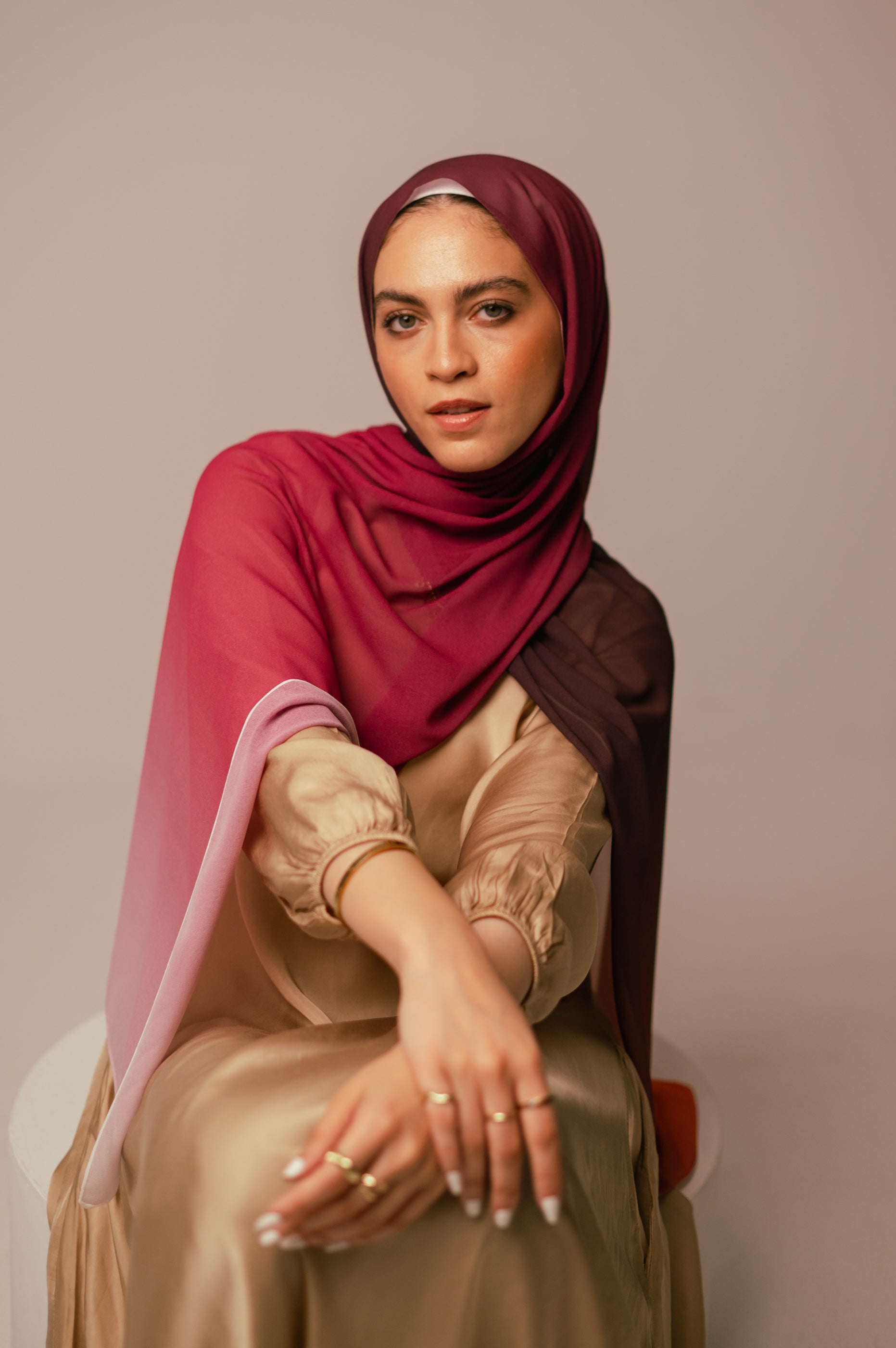 Studio portrait of the Wisteria Sunset hijab showing rich warm tones and fluid chiffon draping.