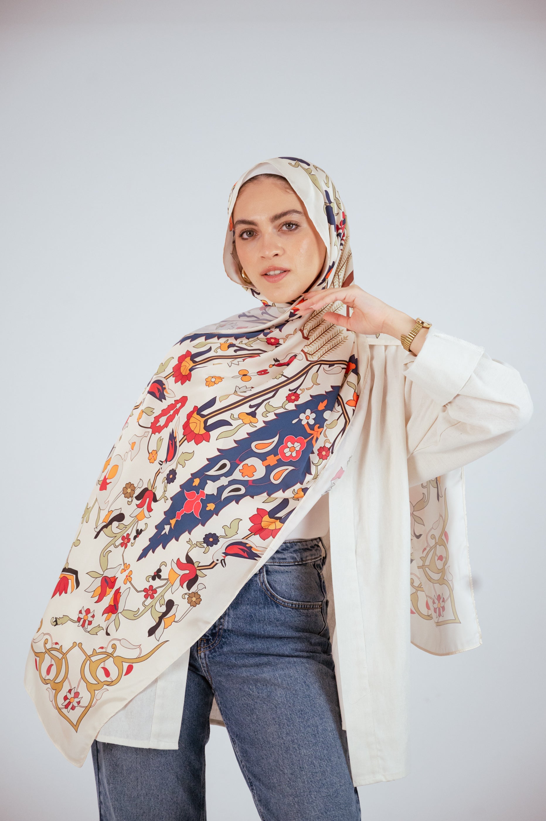 Model wearing the Andalus Satin Hijab in an ivory and gold Andalusian pattern, front view