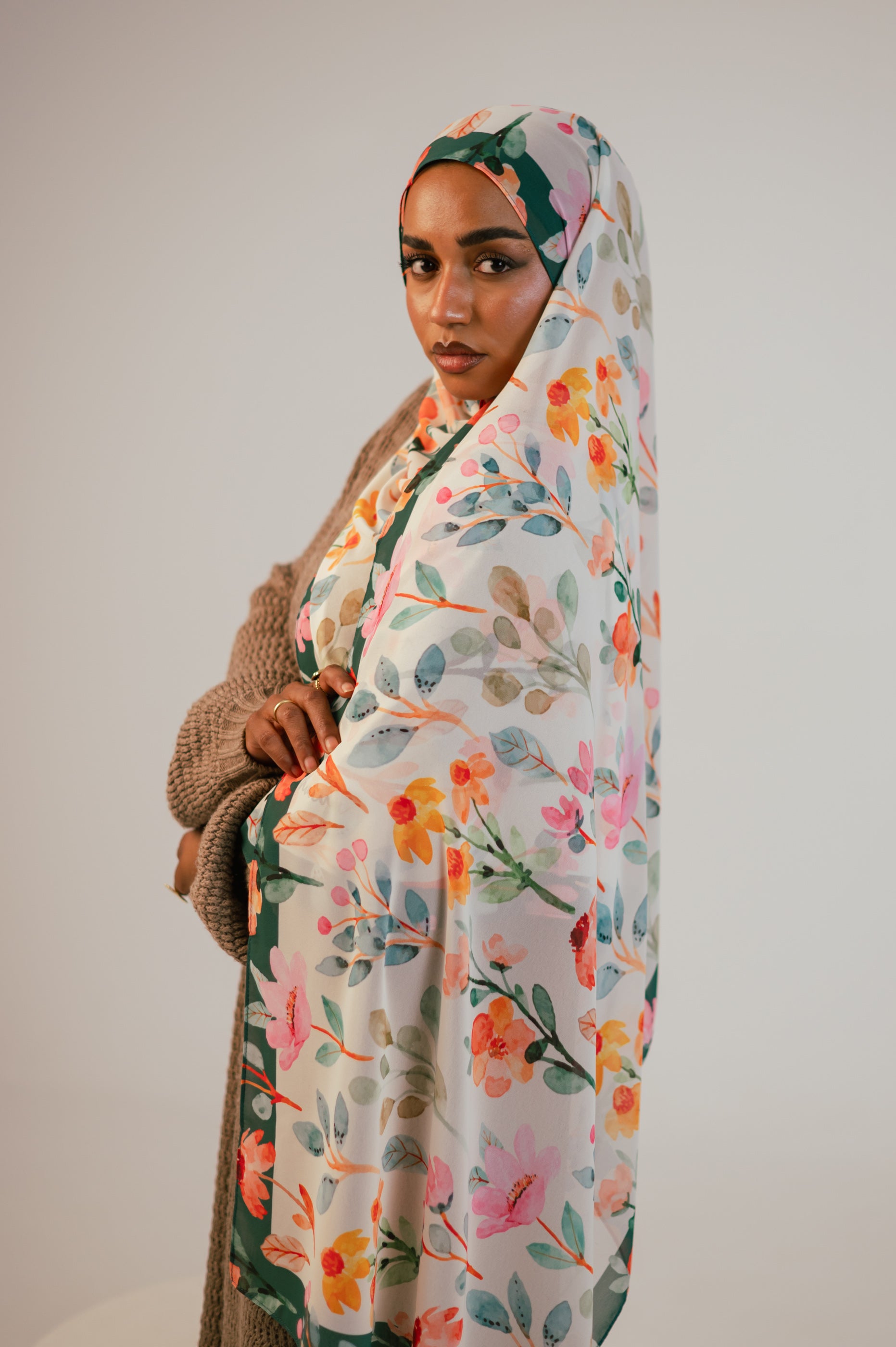 Full-pattern showcase of Blooms of Hope luxury chiffon hijab with pastel florals and green frame.