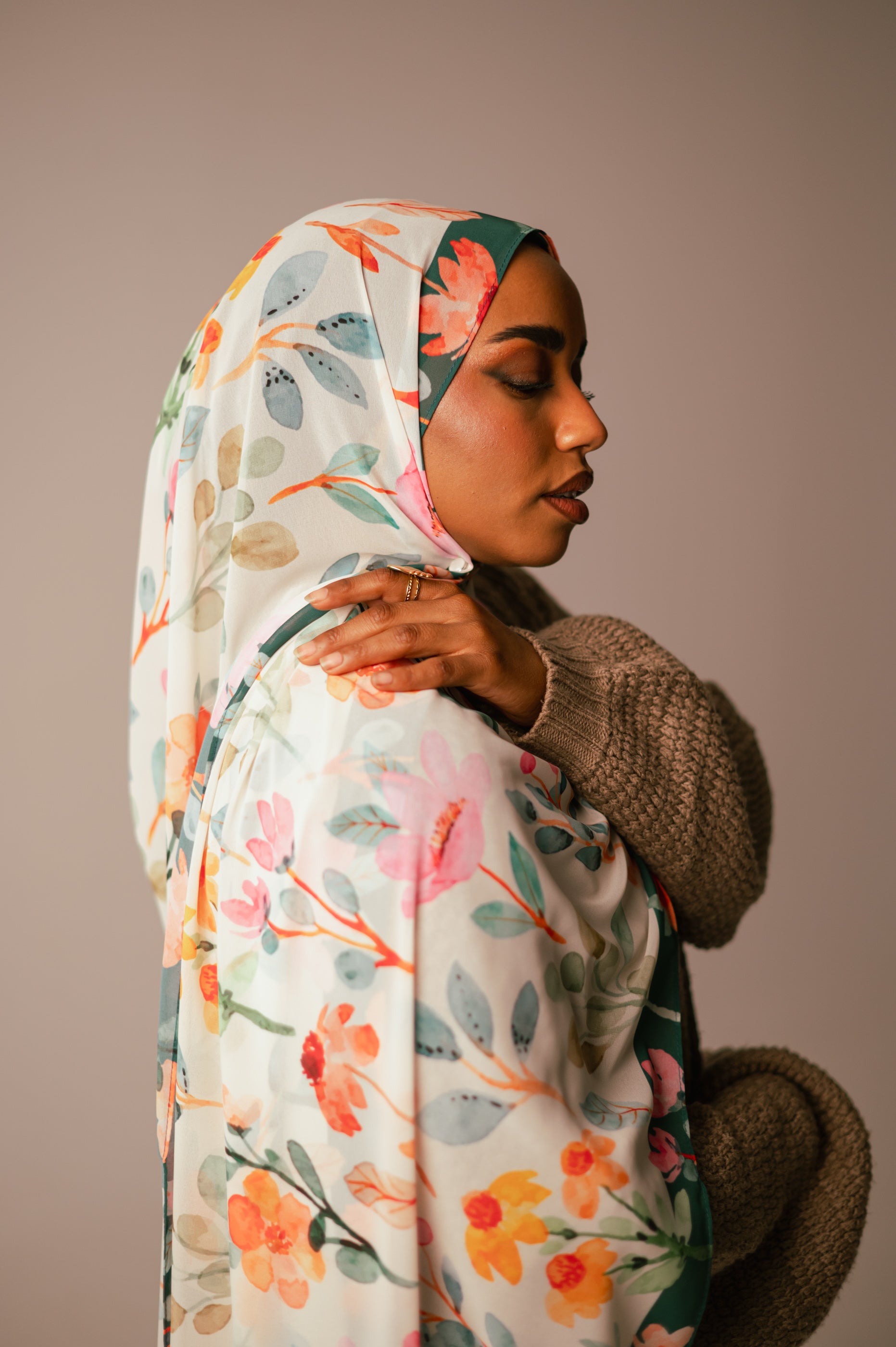 Profile angle of model wearing the Blooms of Hope chiffon hijab with soft botanical artwork and elegant drape.