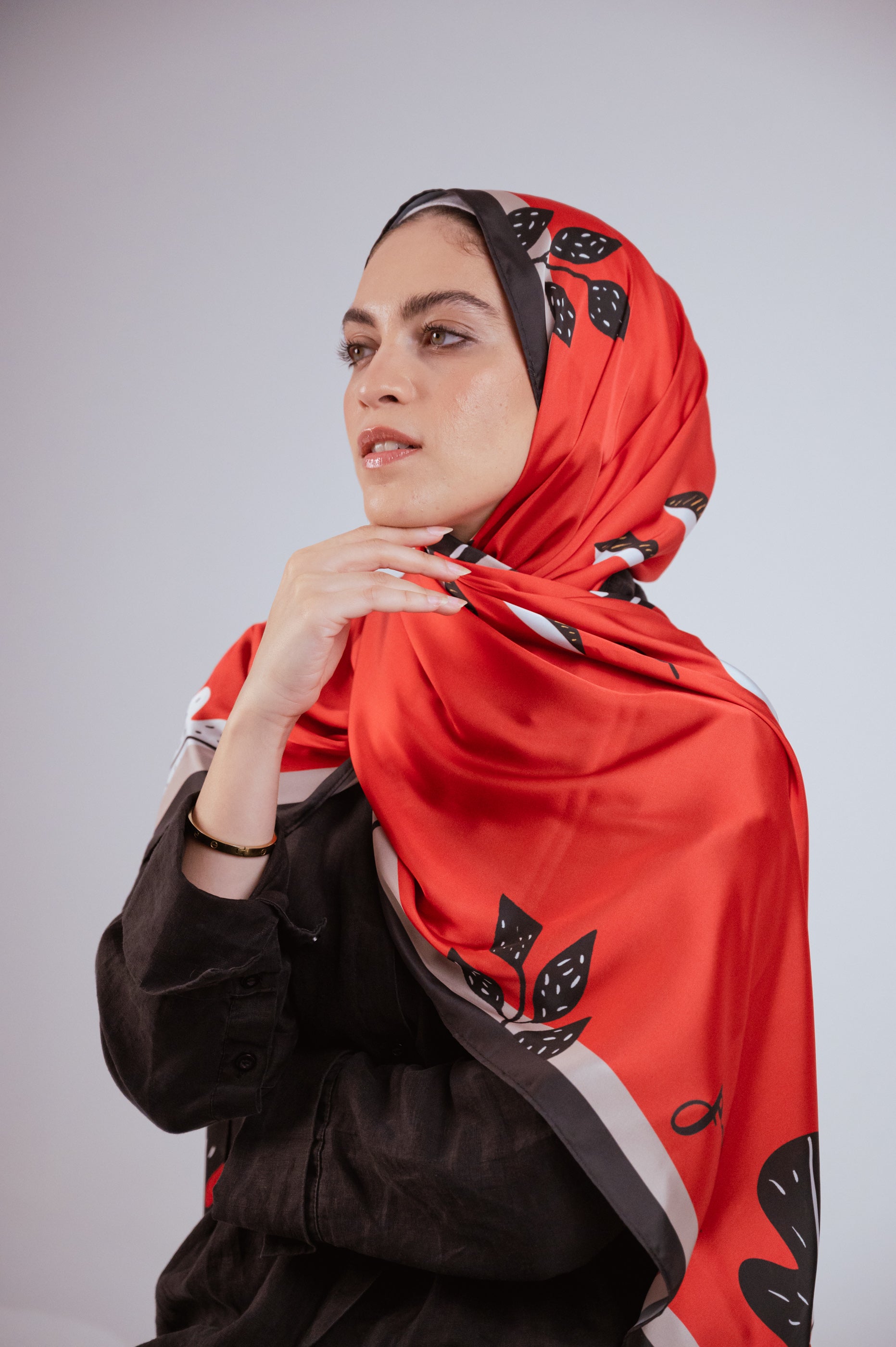 Side-profile photo of the Bold Botanica satin hijab, showing the smooth satin texture and bold leaf detailing.