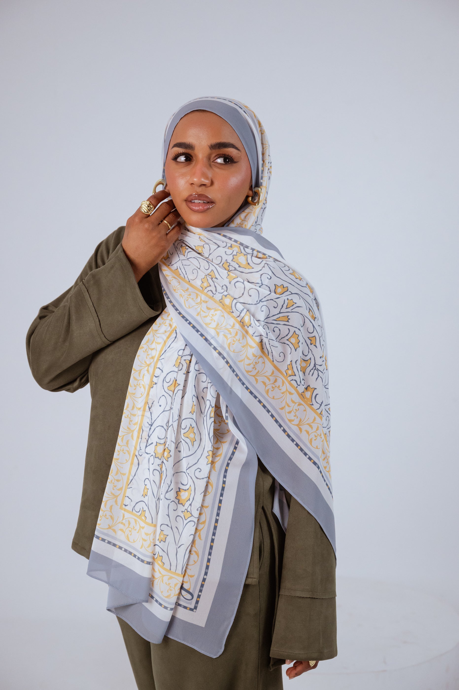 Full view of the Ciel Doré luxury chiffon hijab, showcasing its warm golden gradient and airy drape.