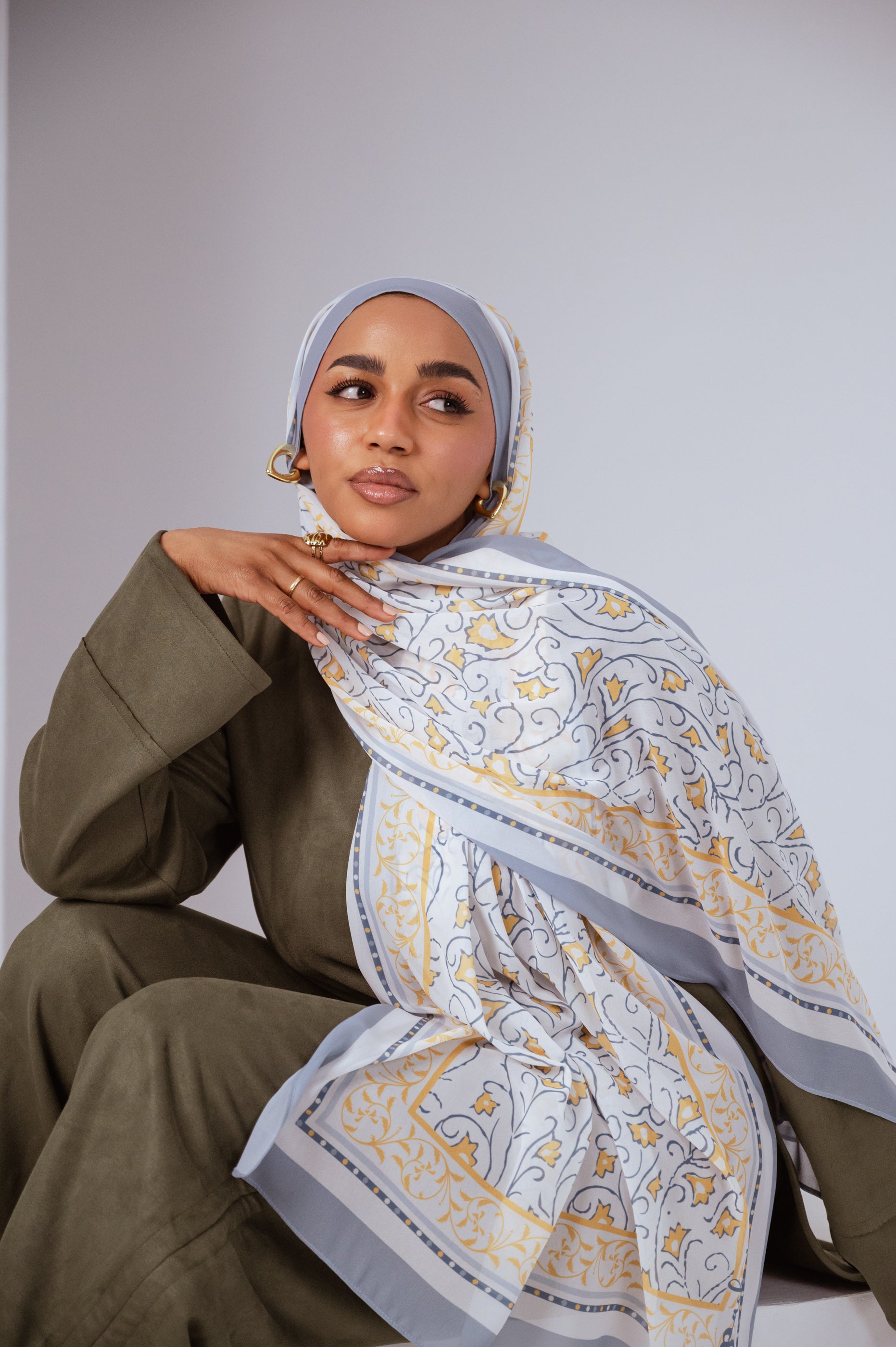 Full view of the Ciel Doré luxury chiffon hijab, showcasing its warm golden gradient and airy drape.