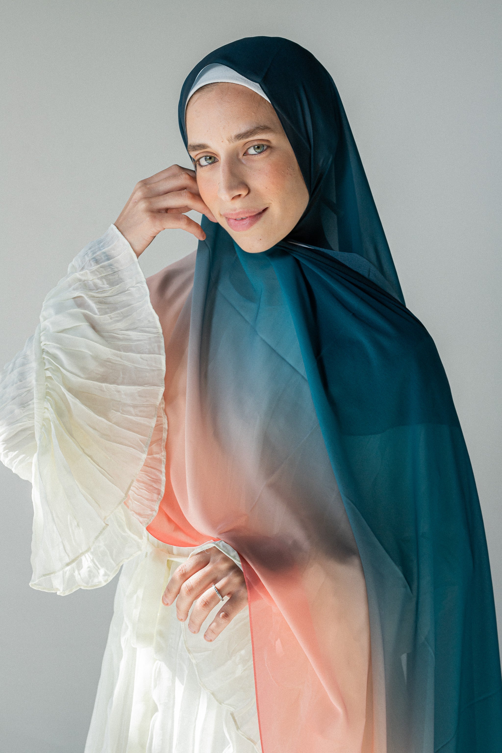 Model wearing Coral Horizon chiffon hijab with teal-to-coral gradient