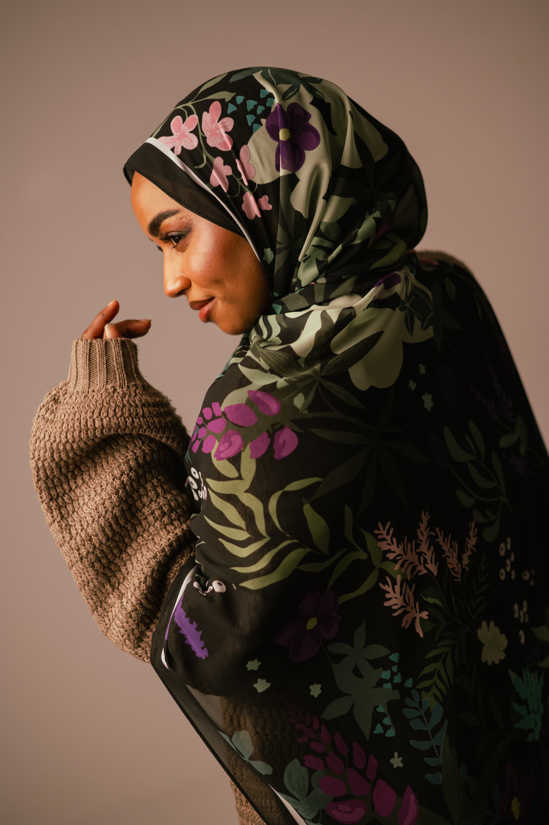 Elegant profile shot of the model wearing the Garden of Whispers chiffon hijab, highlighting the satin-like sheen and print.