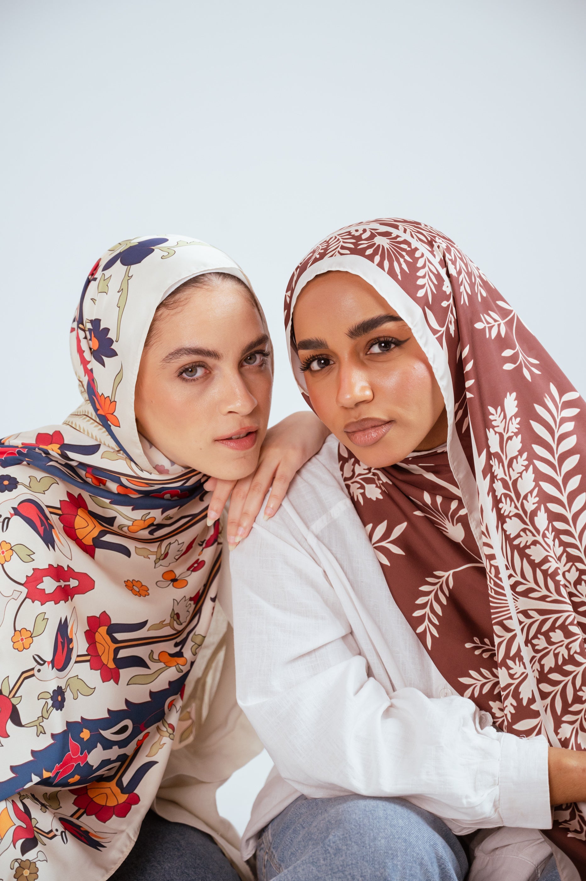 Side-by-side pose featuring Andalus Drape Satin Hijab and Rose of Petra Satin Hijab in warm, neutral tones.