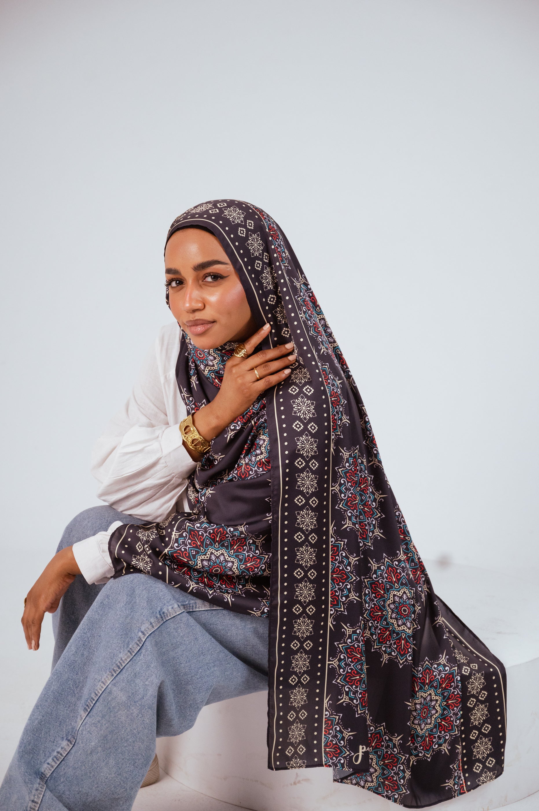 Model wearing the Andalusia Satin Edition Hijab in deep navy with Andalusian medallion print.