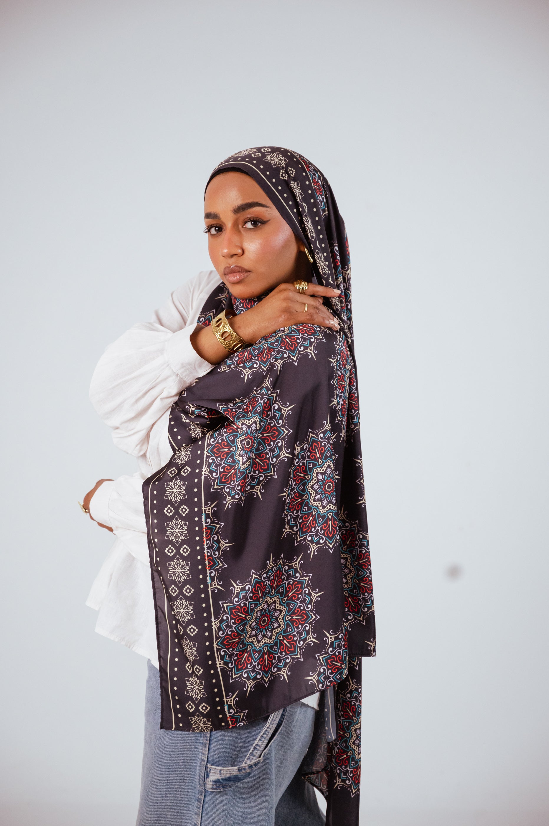 Close-up of model wearing the Andalusia Satin Hijab with gold accessories.