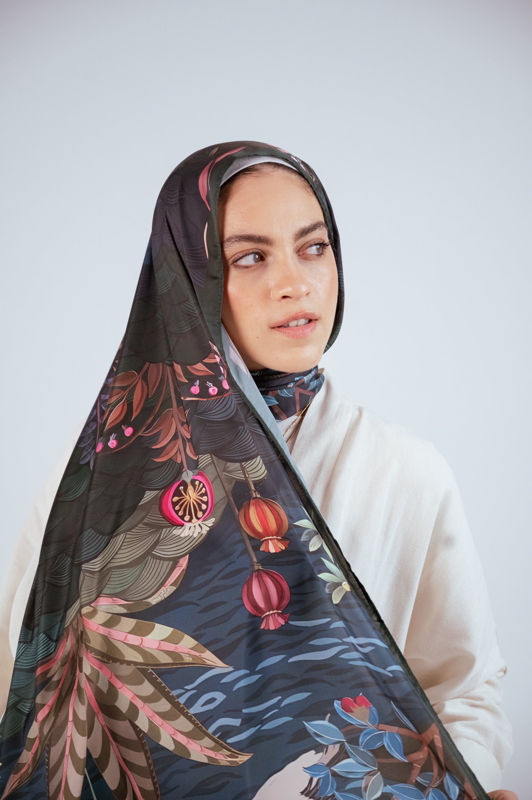 Model facing forward with prominent floral and pomegranate motifs.