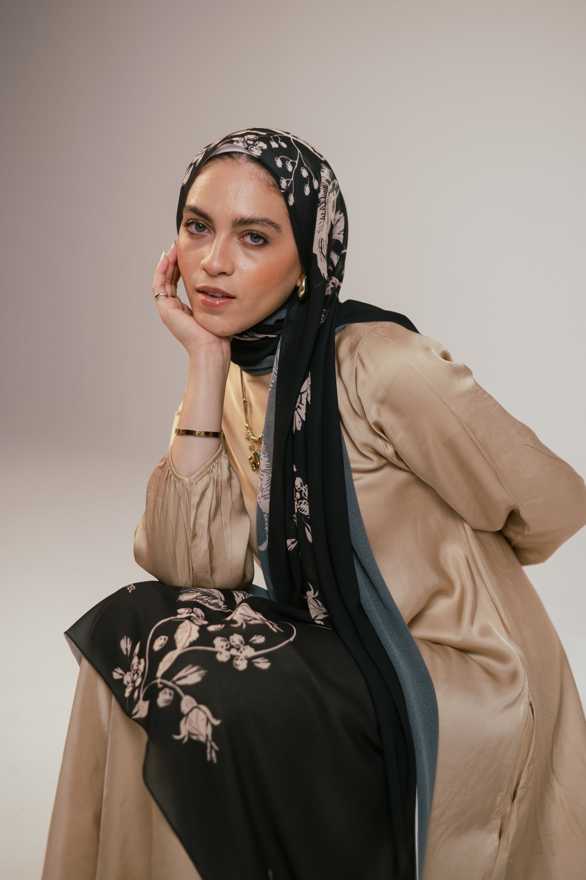 Portrait view of the model wearing Petal Shadows luxury chiffon hijab, styled elegantly with visible floral accents.