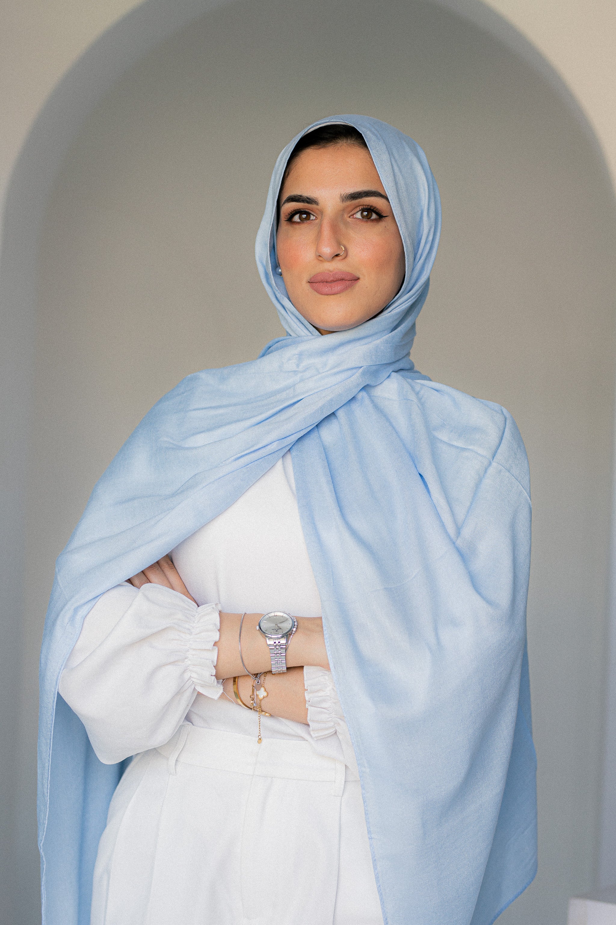 Model wearing the Morning Sky Modal Cotton Hijab in soft blue, showing its lightweight drape, smooth texture, and elegant flow in natural light — part of Jaida’s luxury modest collection.