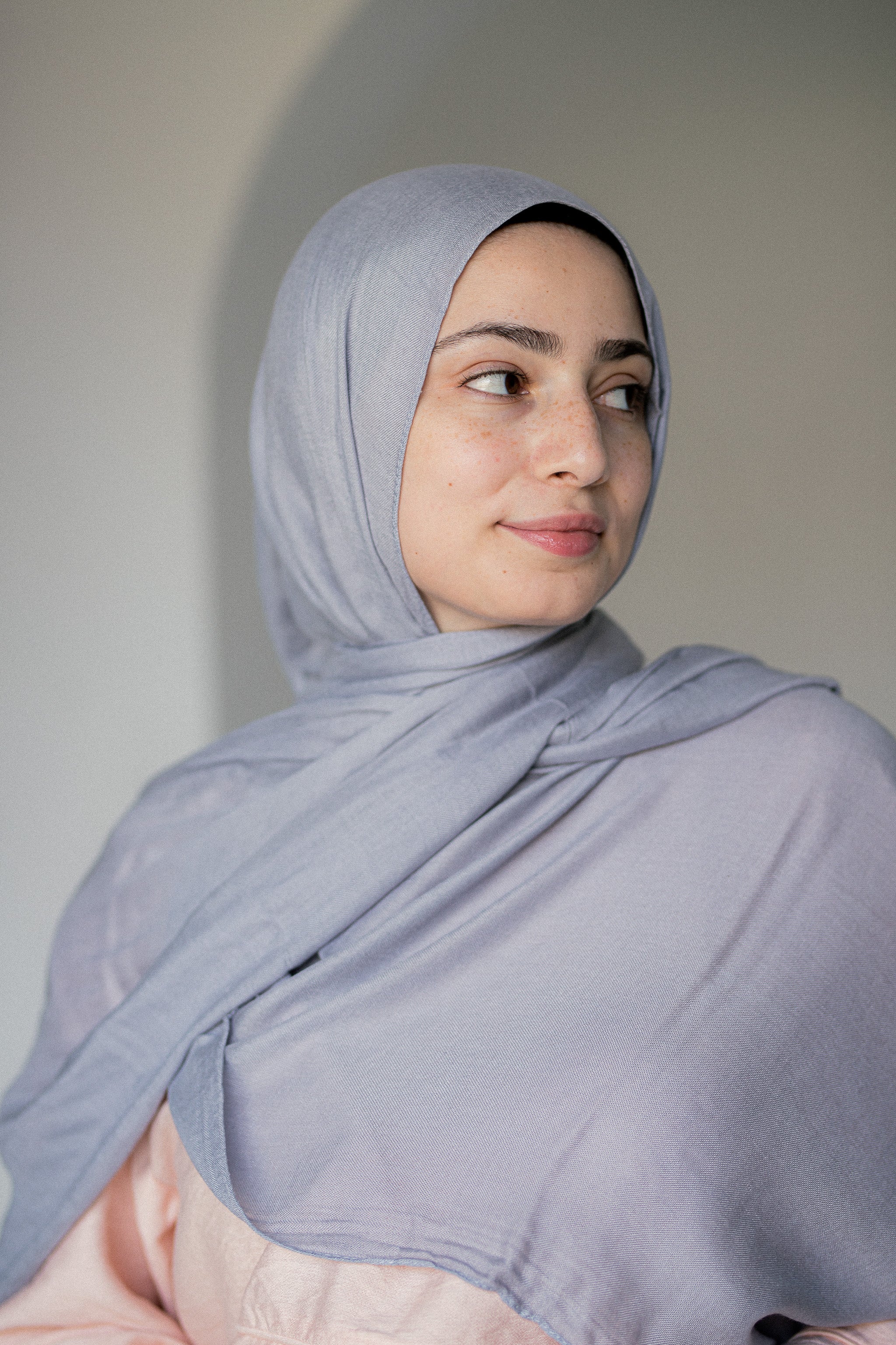 Moonstone Modal Cotton Hijab in motion – showcasing its fluid drape and soft misty hue under natural light
