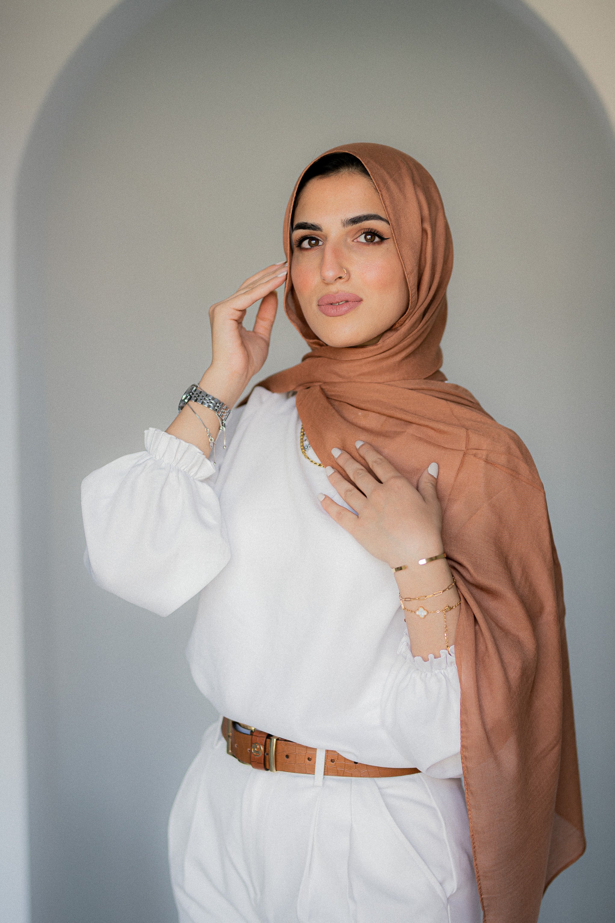 Model wearing Sahara Dusk modal cotton hijab in warm caramel tone, softly draped for an elegant look.