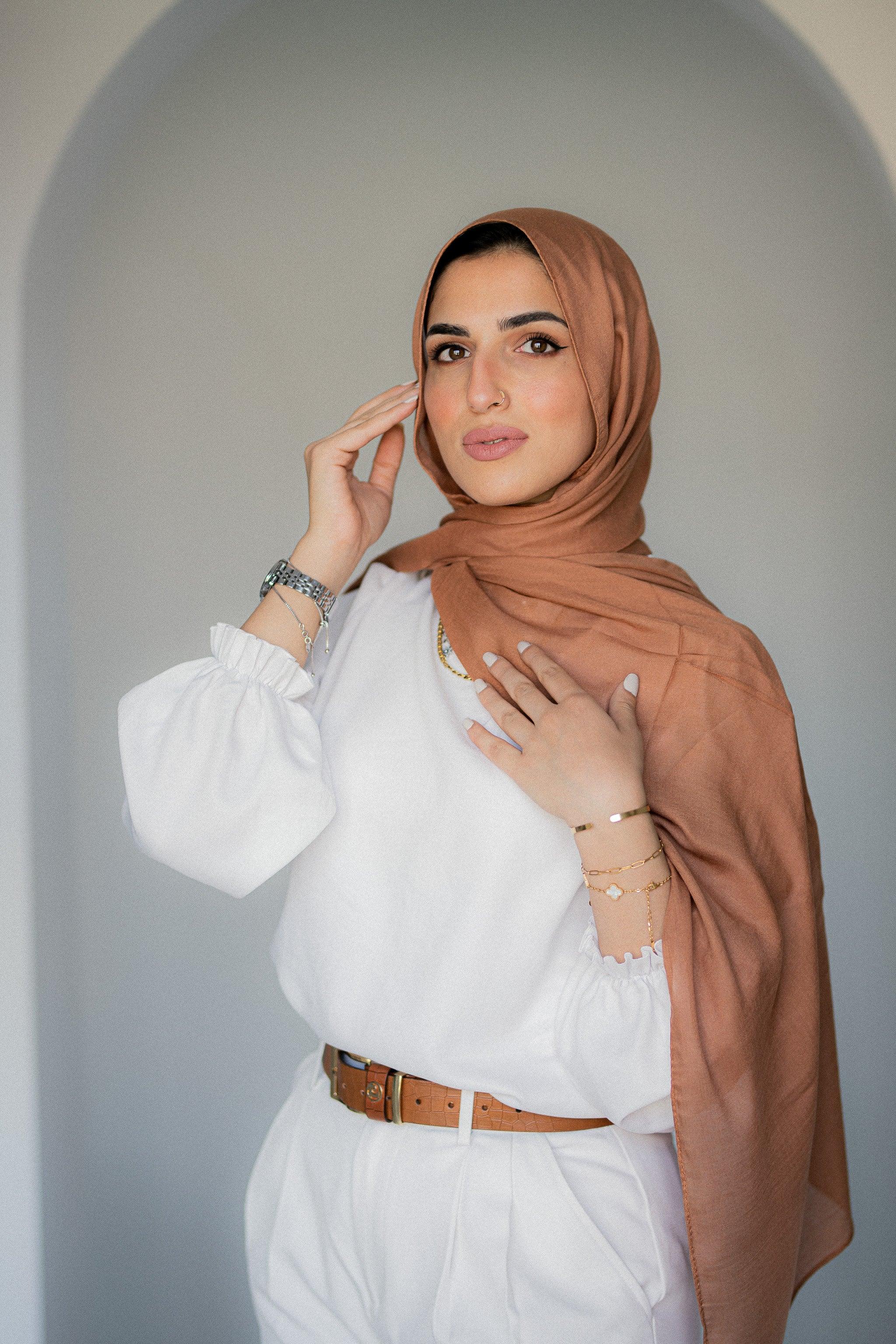 Model wearing Sahara Dusk modal cotton hijab in warm caramel tone, softly draped for an elegant look.