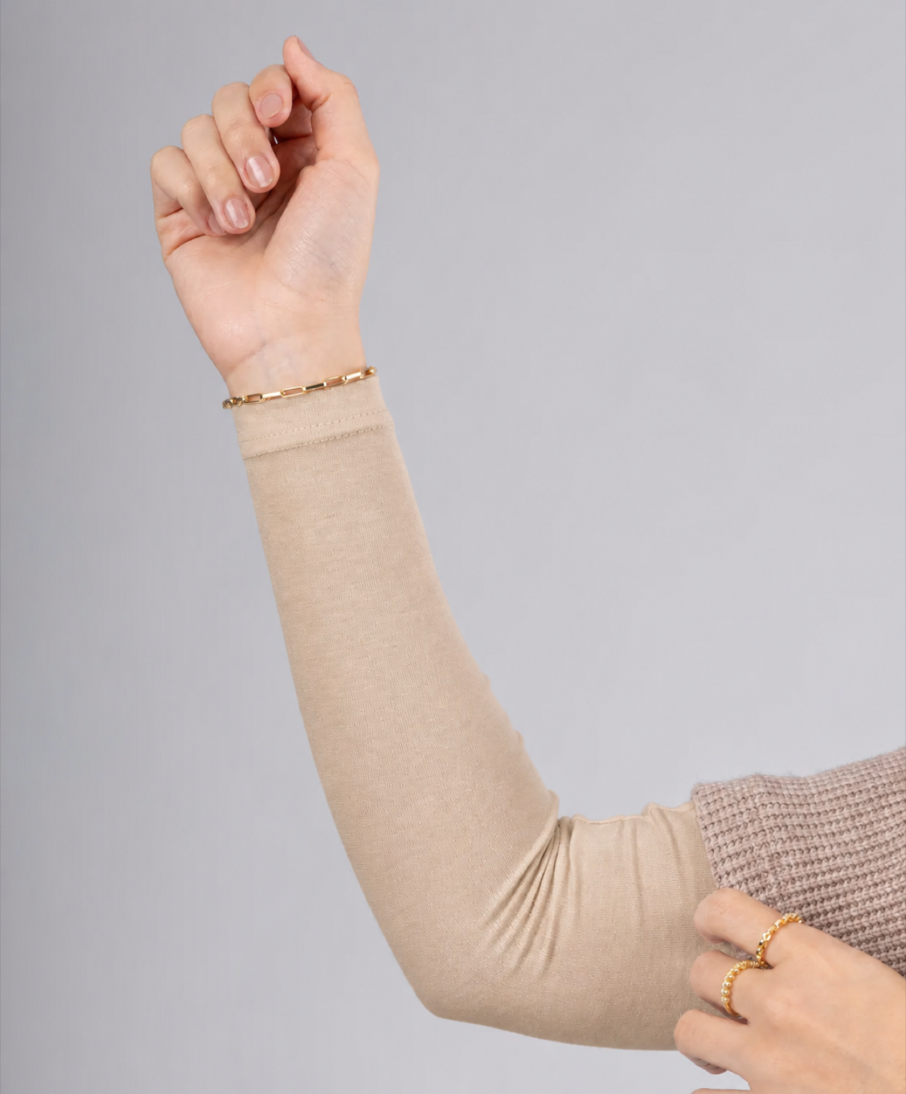 Model wearing a warm sand beige cotton arm cover sleeve