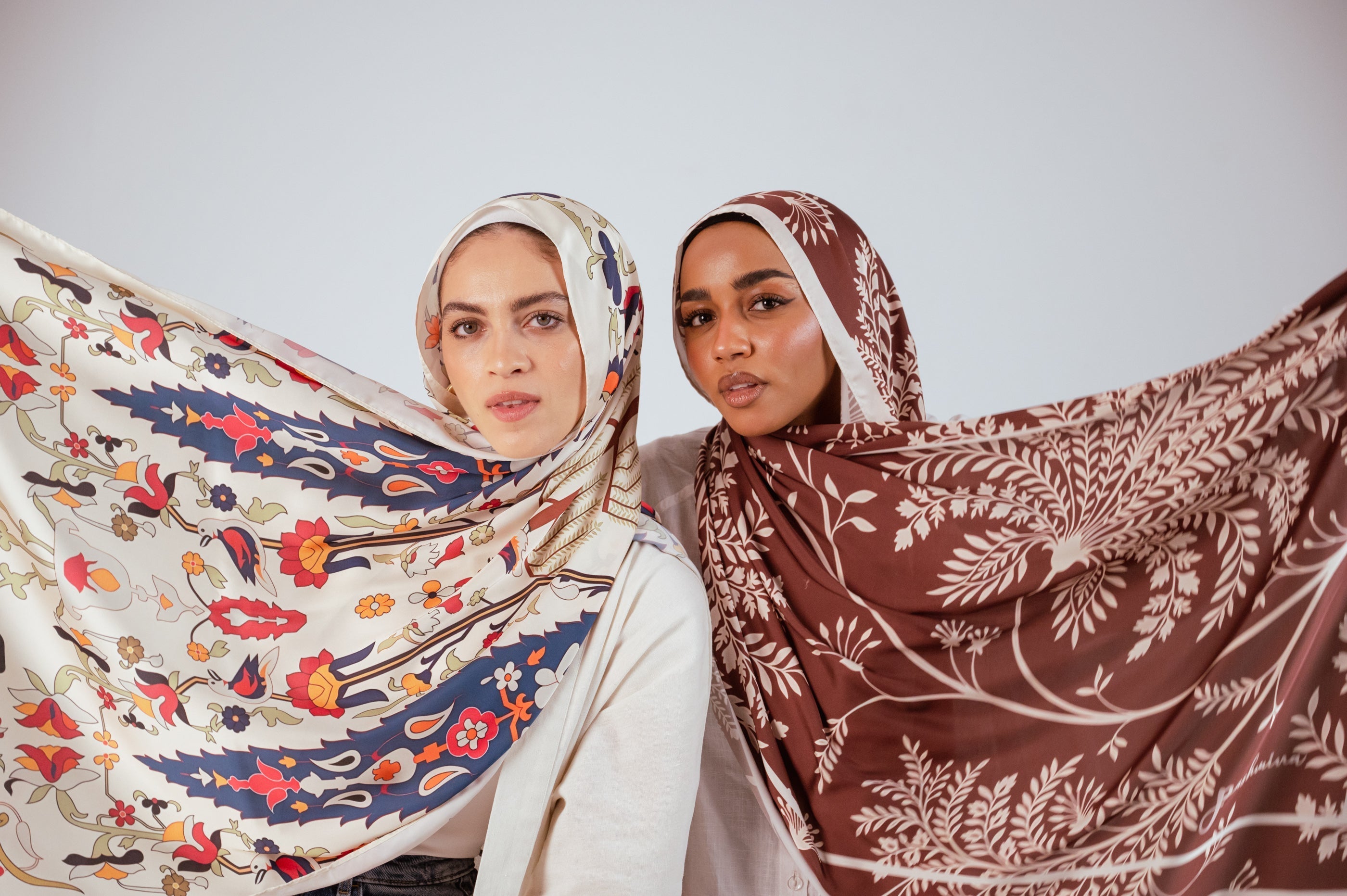 two models wearing andalus drape and rose of petra hijab