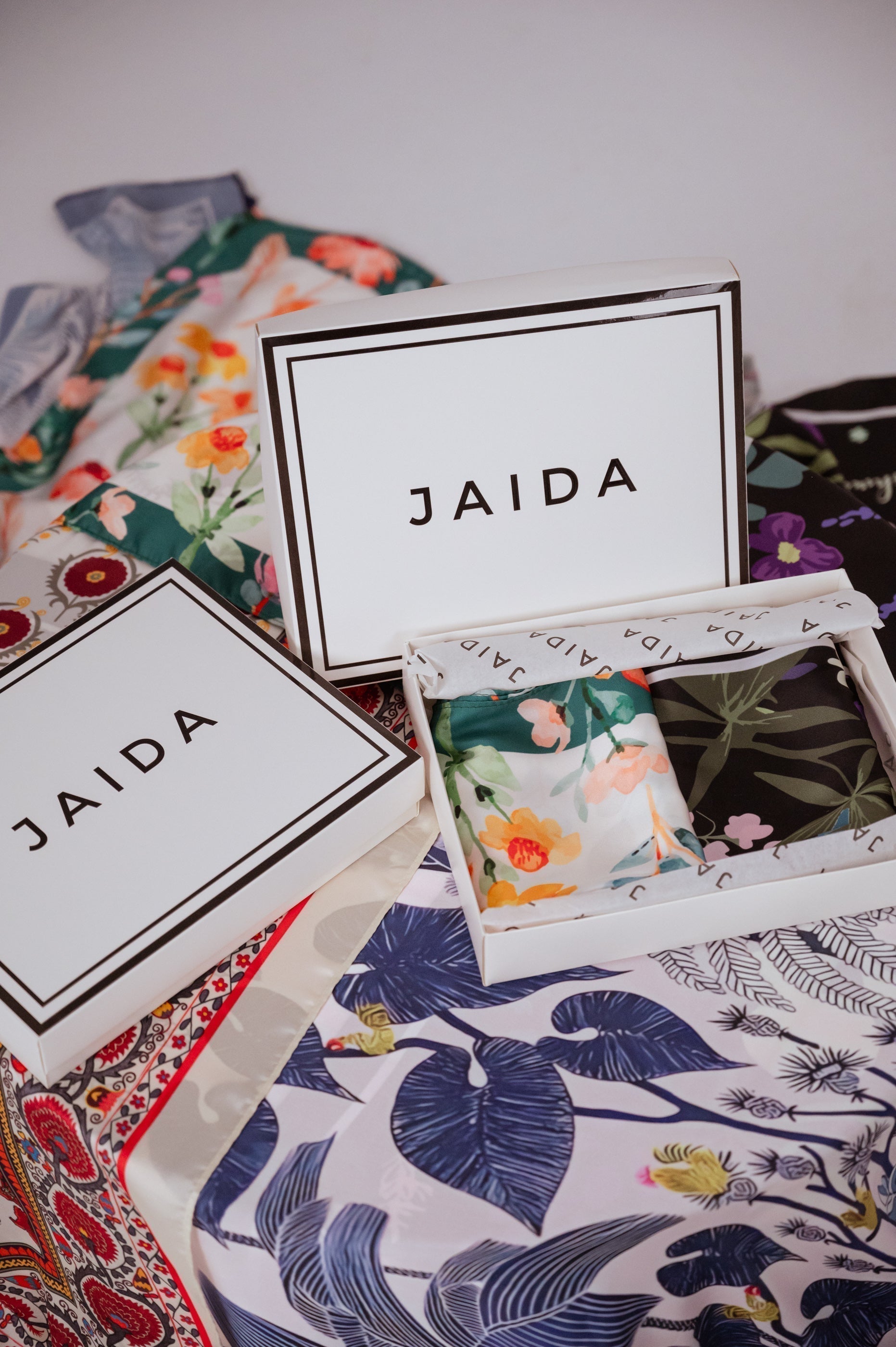 JAIDA luxury chiffon hijabs flat lay with gift boxes and printed scarves