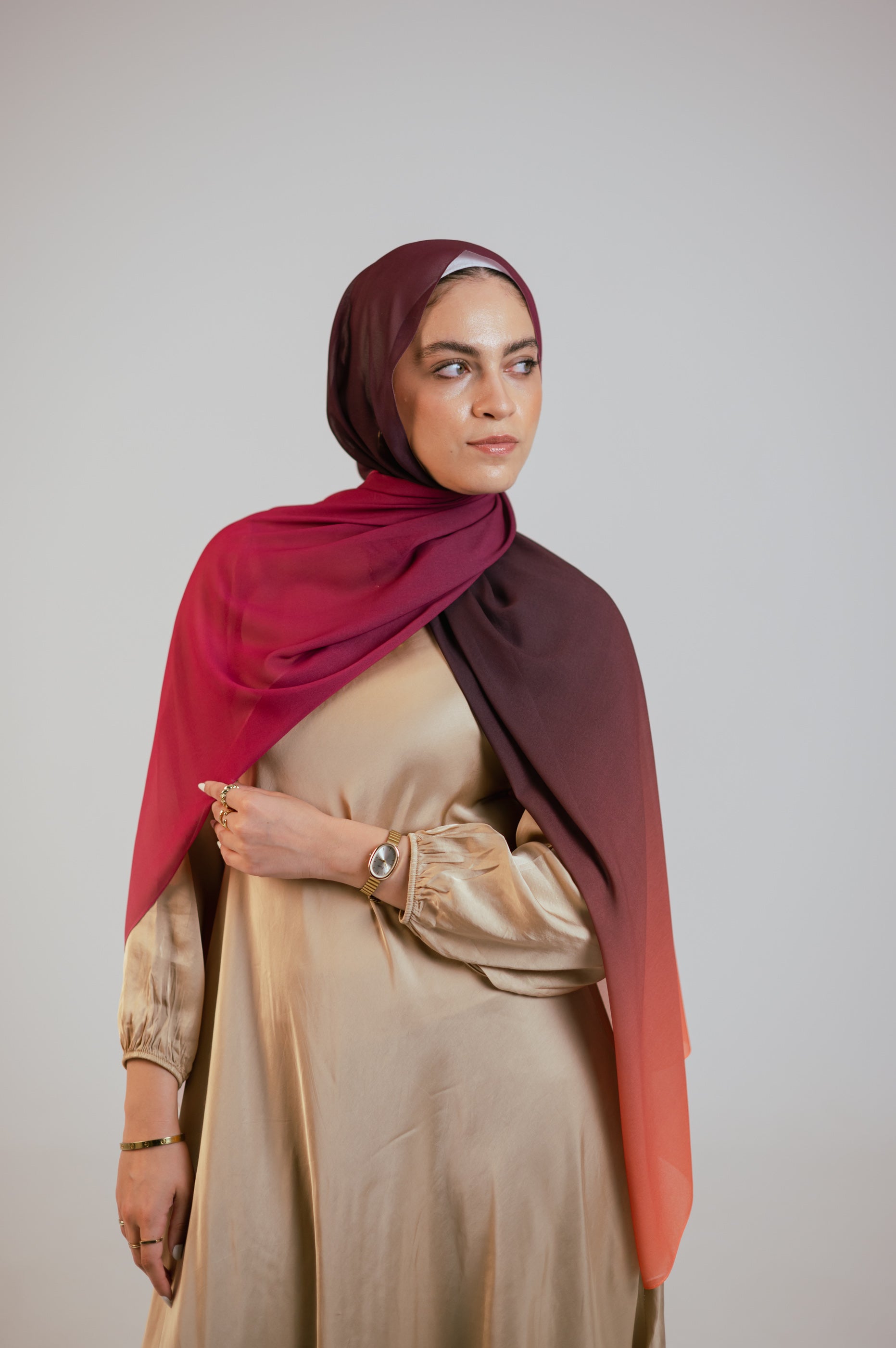 Model wearing the Wisteria Sunset chiffon hijab styled front-facing with soft ombré drape across the shoulder.