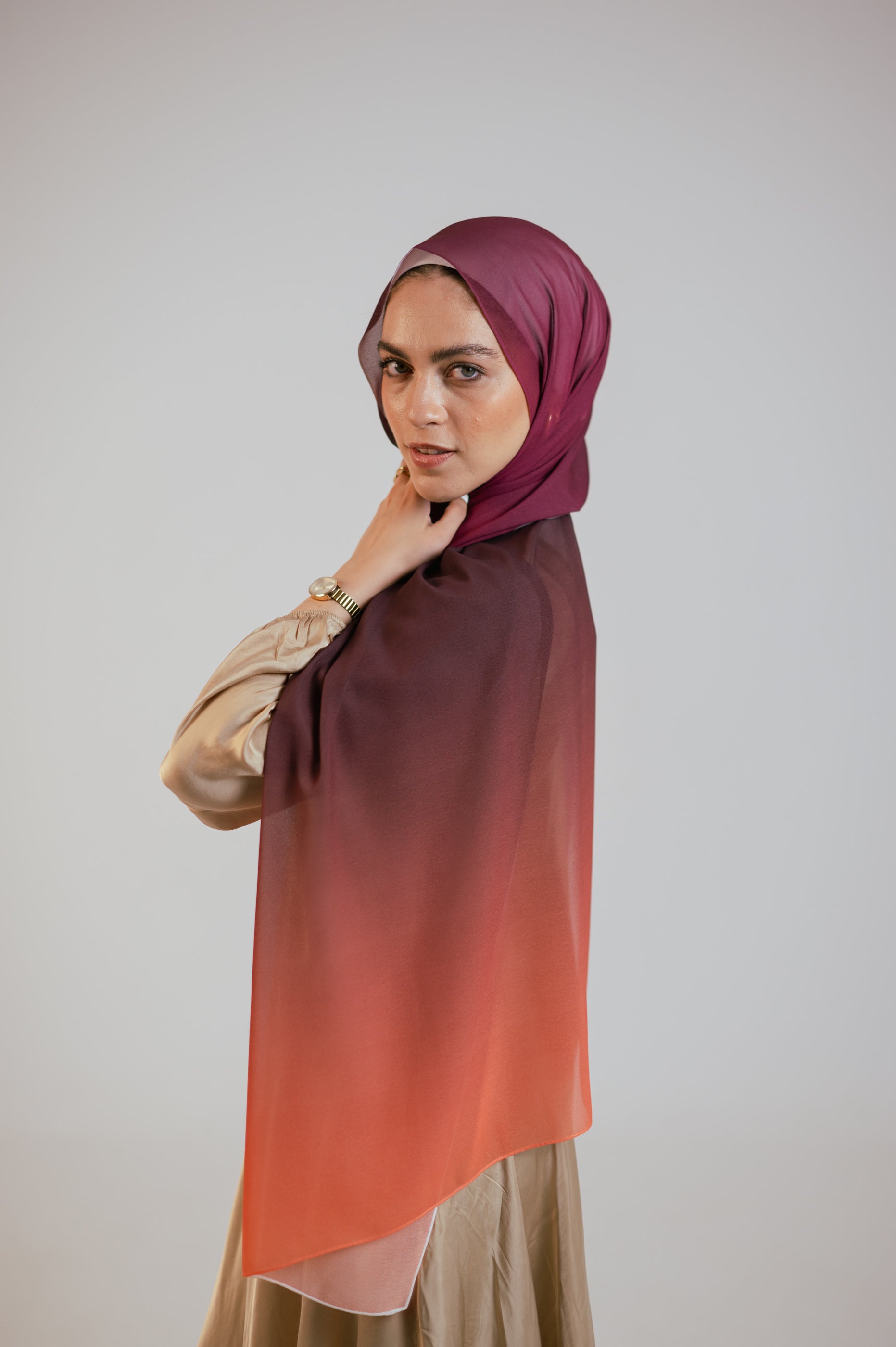 Front view of the Wisteria Sunset hijab with visible plum-to-orange ombré transition on the shoulder.