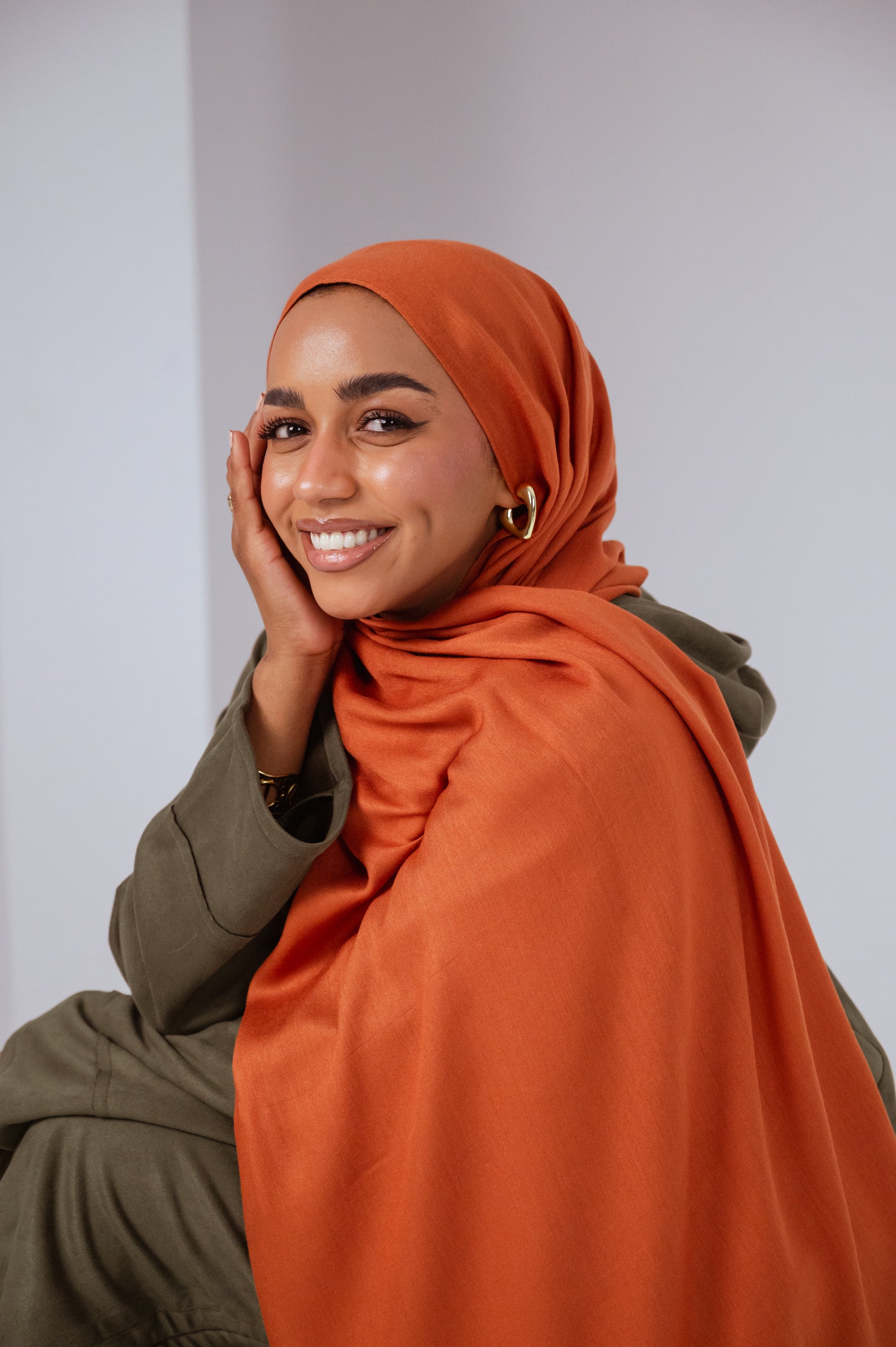 Model wearing Afire Modal Cotton Hijab styled in front drape – elegant rust hue for everyday wear.