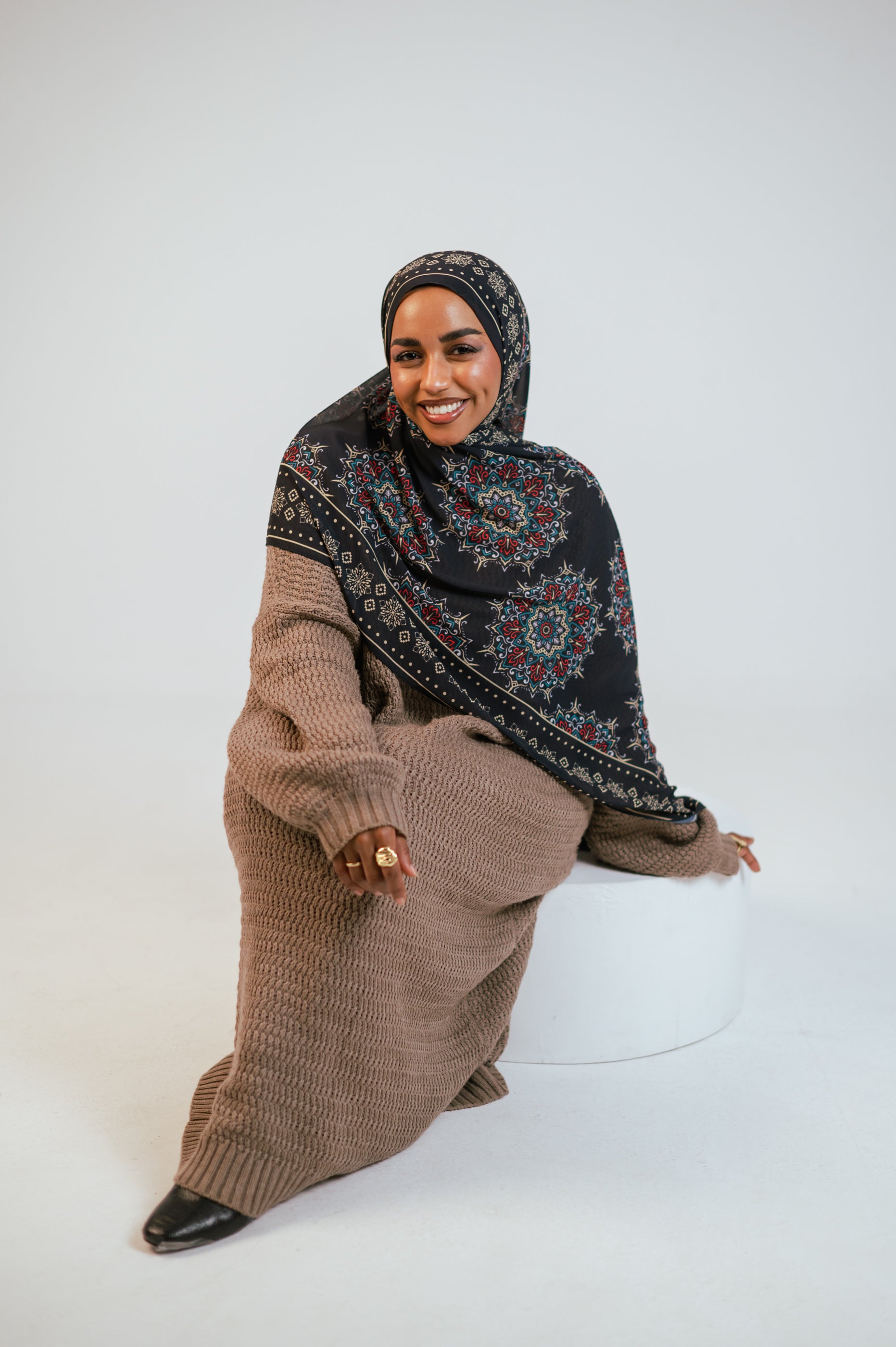 Close macro portrait of the Andalusia Luxury Chiffon Hijab, showing intricate print motifs and chiffon texture near the face.