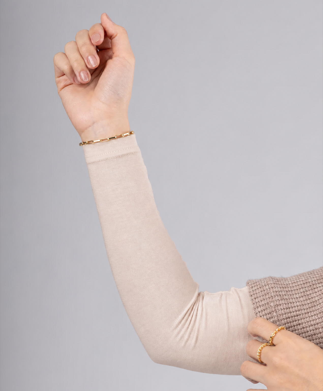 Model wearing a blush beige cotton arm cover sleeve