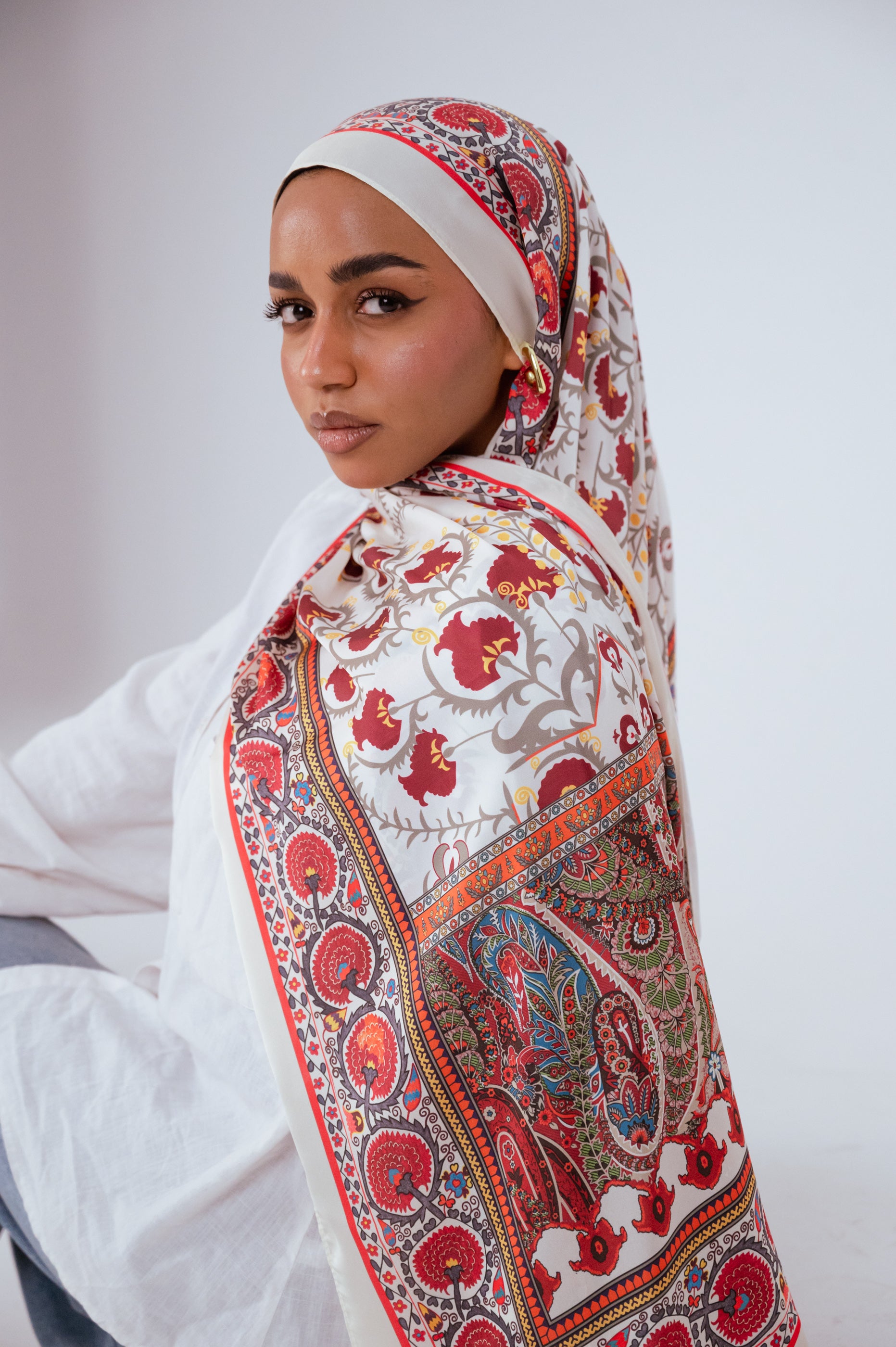 Back drape view of the Cairo Nights Satin Hijab with full pattern visibility in red, orange, and teal tones.