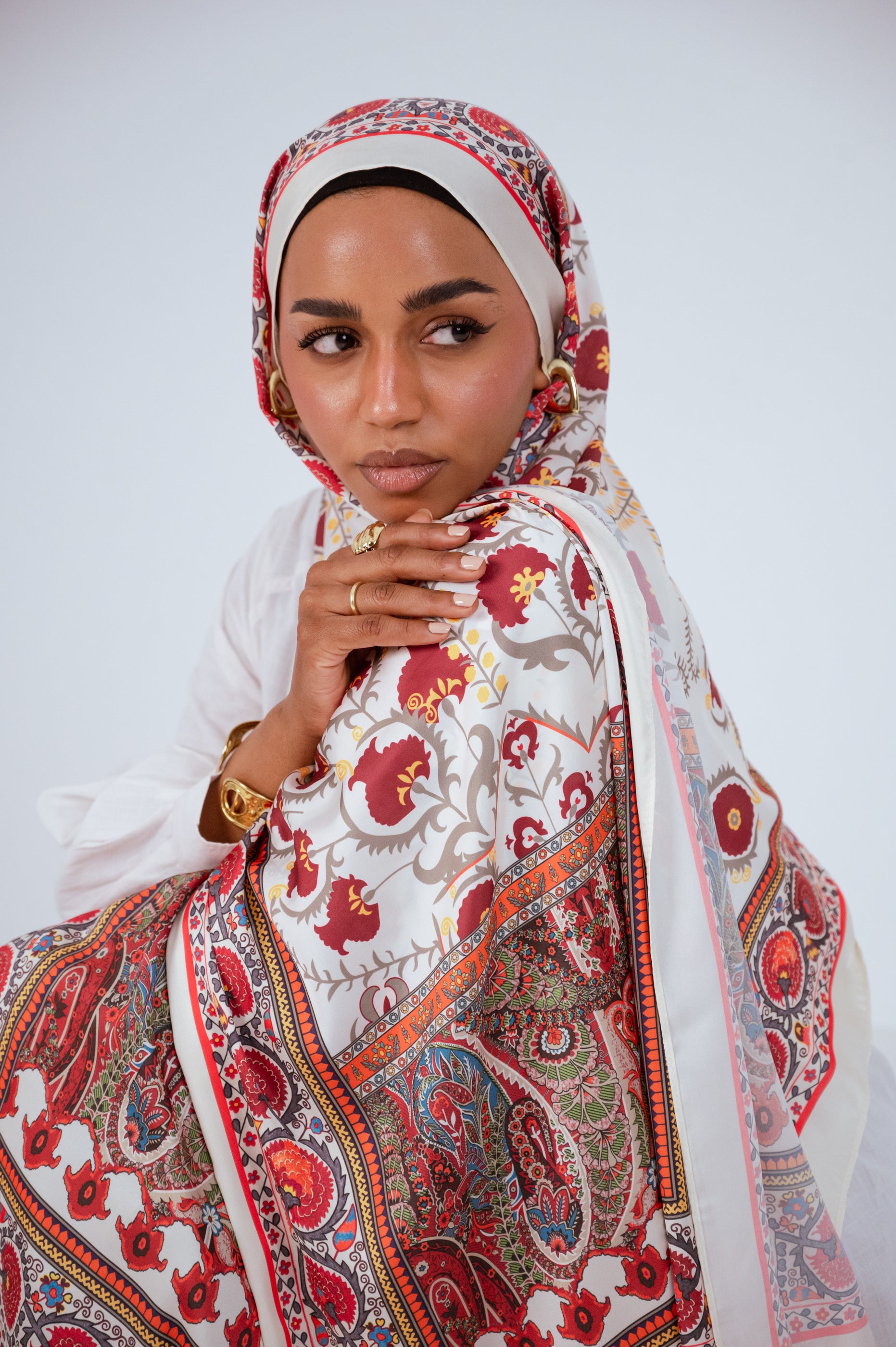 Close-up of the Cairo Nights Satin Hijab draped over the shoulder, highlighting the intricate floral and paisley motifs.