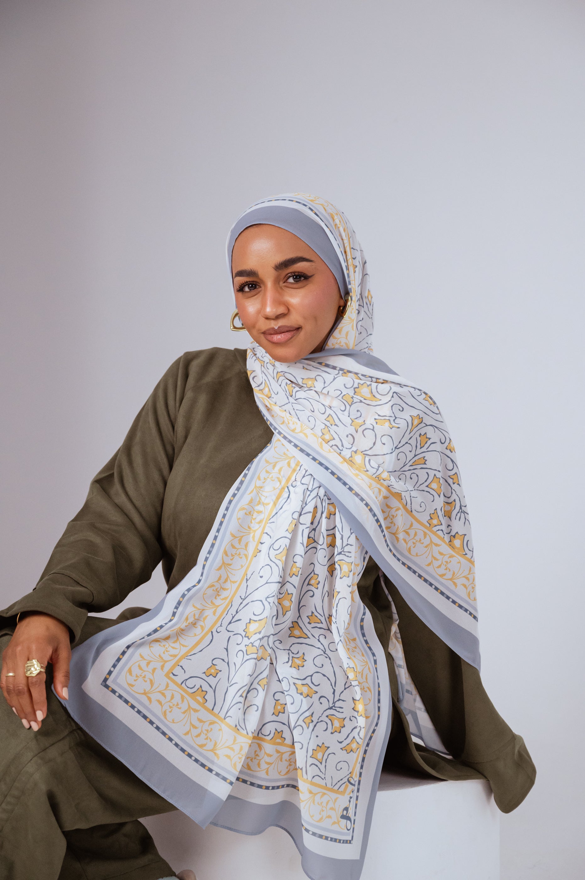 Full view of the Ciel Doré luxury chiffon hijab, showcasing its warm golden gradient and airy drape.