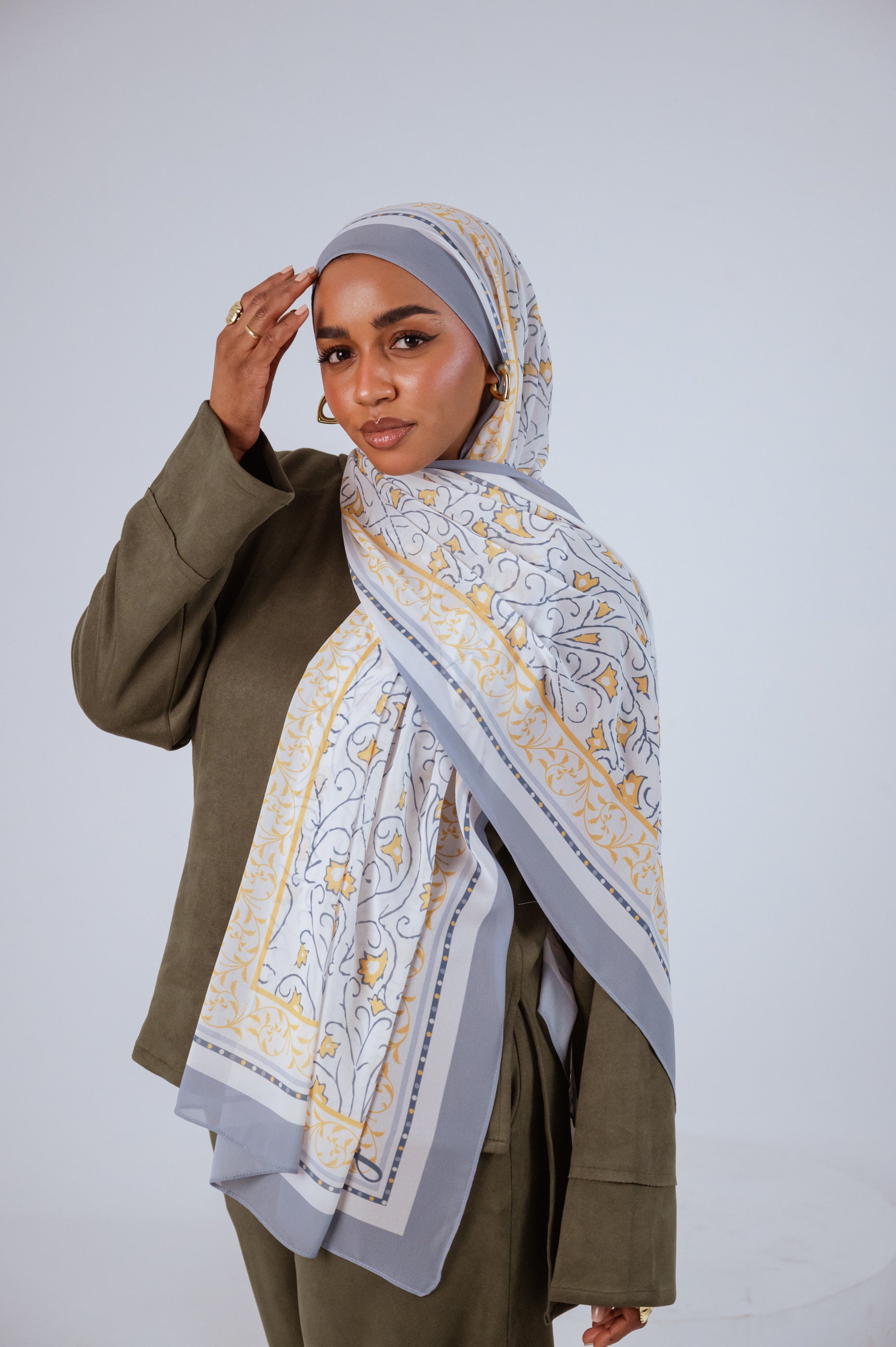 Full view of the Ciel Doré luxury chiffon hijab, showcasing its warm golden gradient and airy drape.