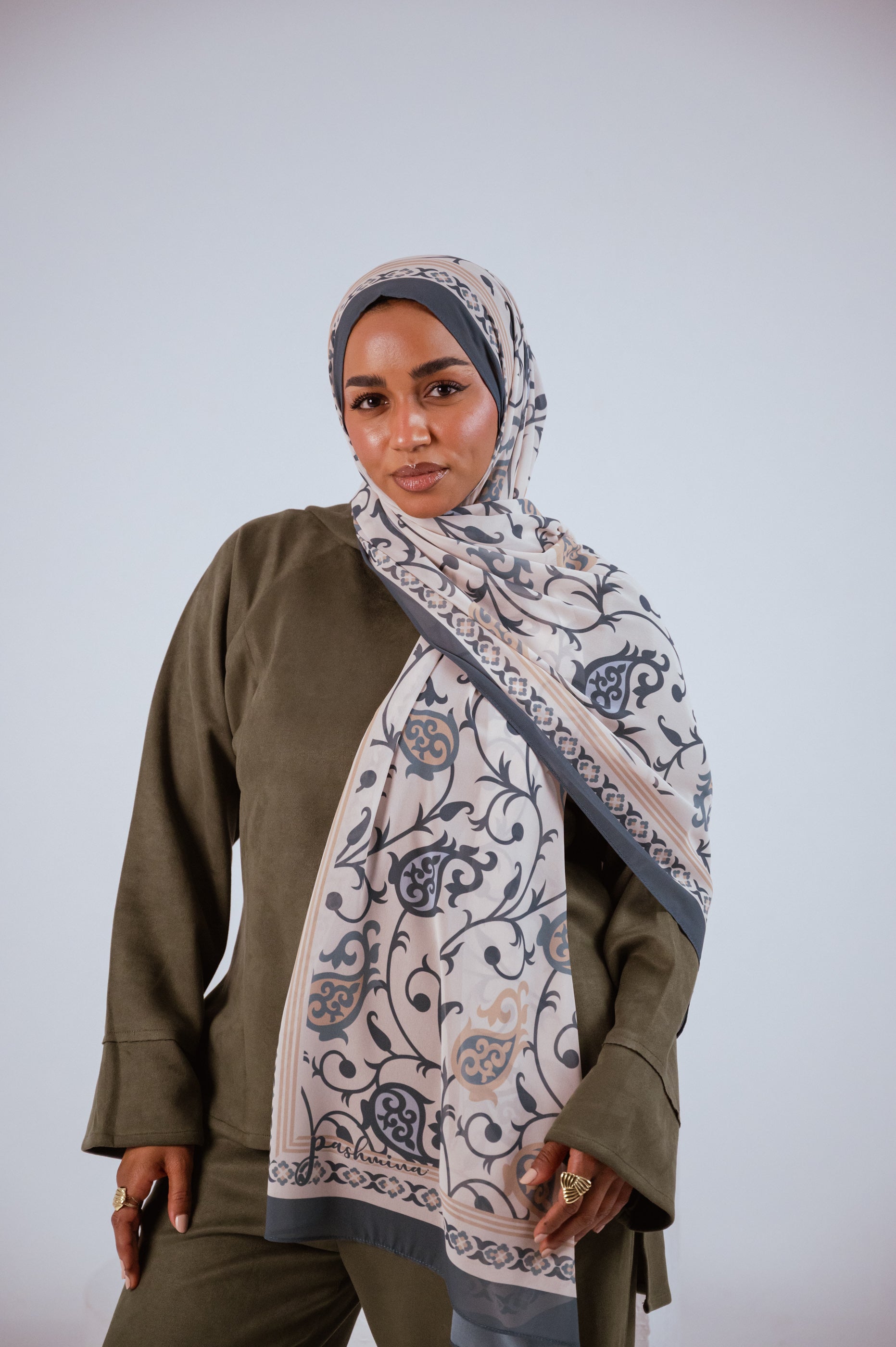 Model wearing Cordoba Serenity hijab in ivory, slate blue, and beige with Andalusian vine patterns.