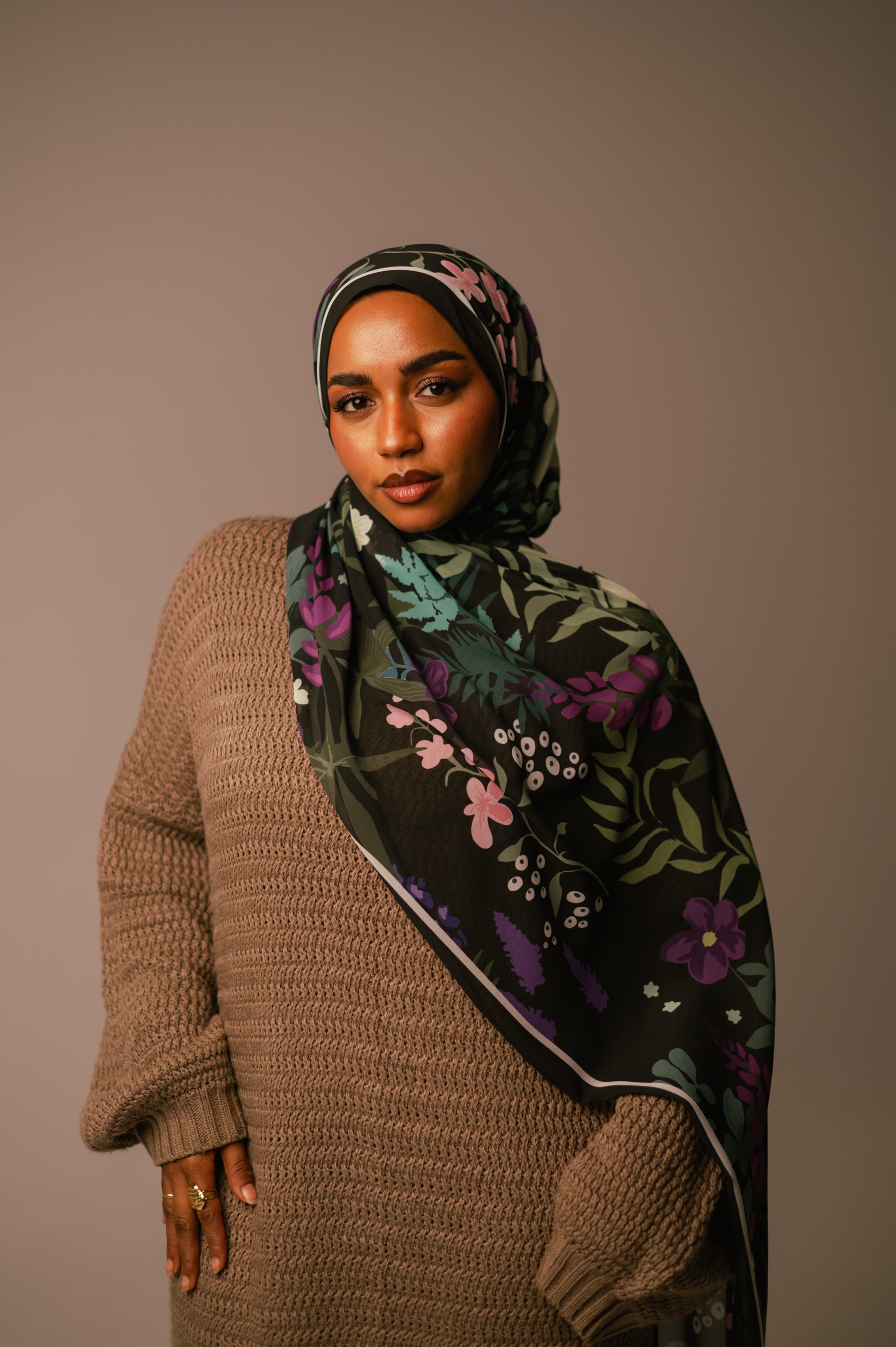 Model facing the camera wearing the Garden of Whispers chiffon hijab, showing the print draped across the shoulder.