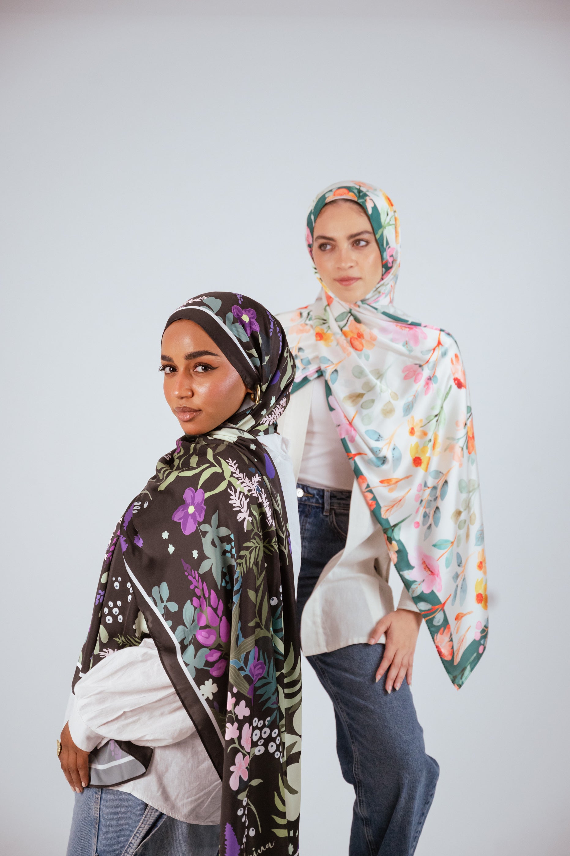 Garden of Whispers satin hijab and Blooms of Hope satin hijab shown together in a styled standing pose.
