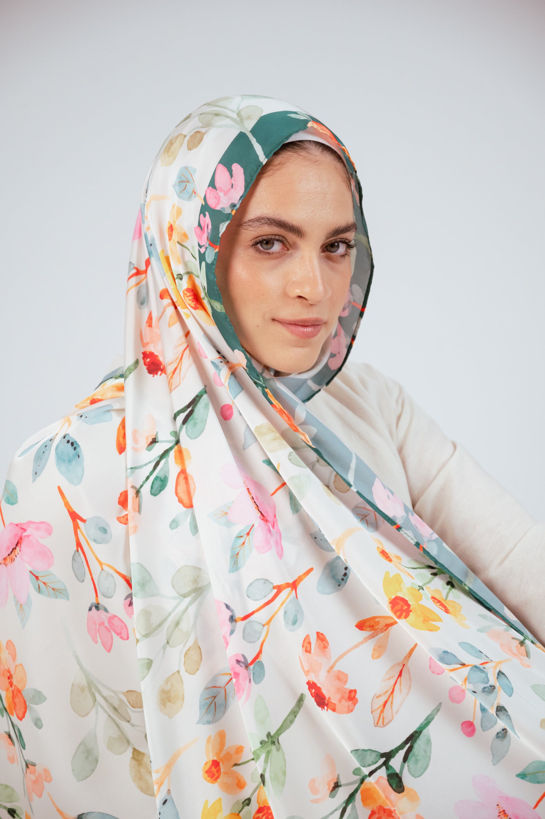Close-up of Blooms of Hope – Luxury Satin Hijab fabric, highlighting watercolor florals and smooth satin texture.
