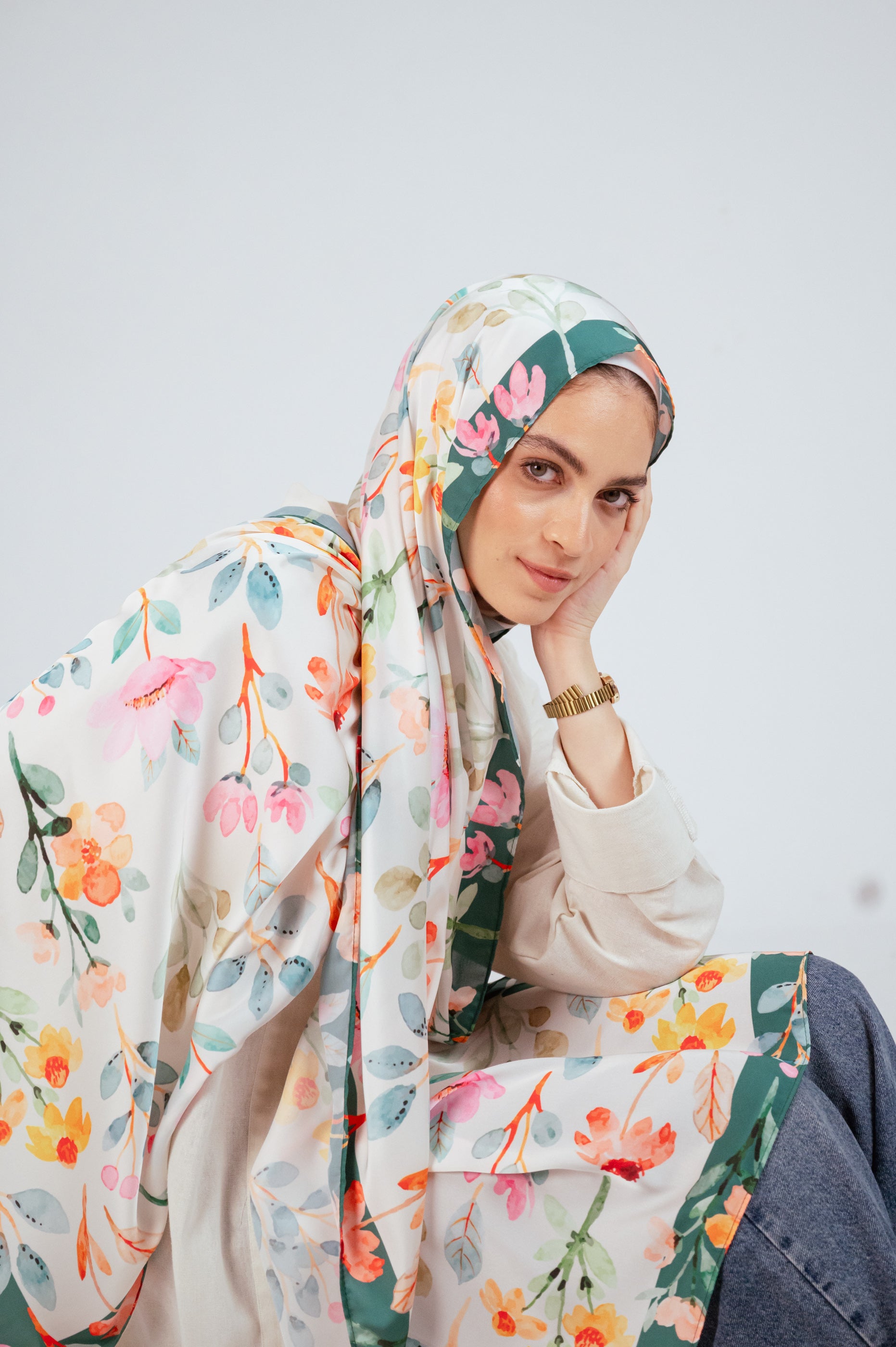 Artistic shot of Blooms of Hope – Luxury Satin Hijab cascading over the shoulder, showing full print and border.