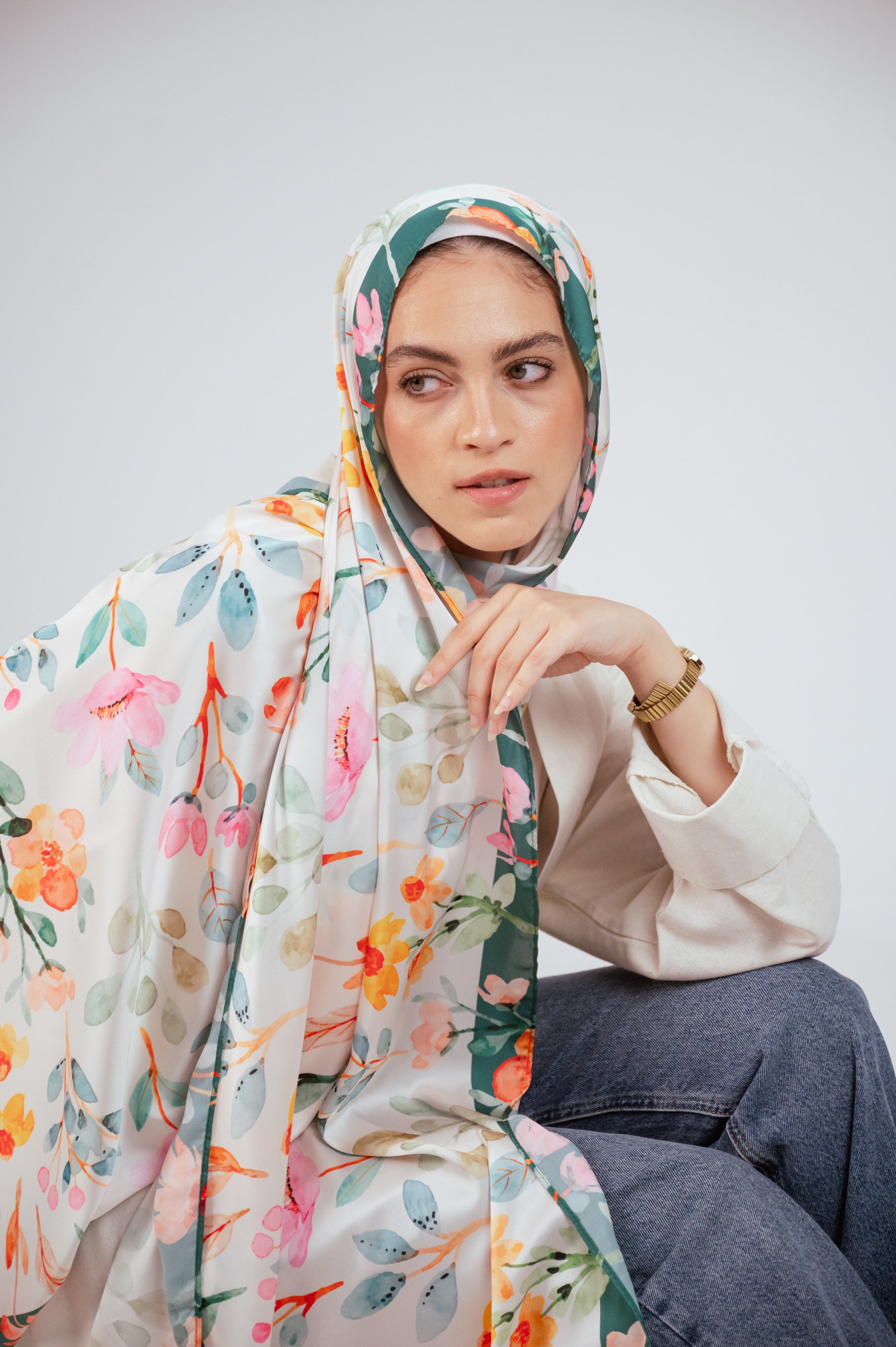 Artistic shot of Blooms of Hope – Luxury Satin Hijab cascading over the shoulder, showing full print and border.