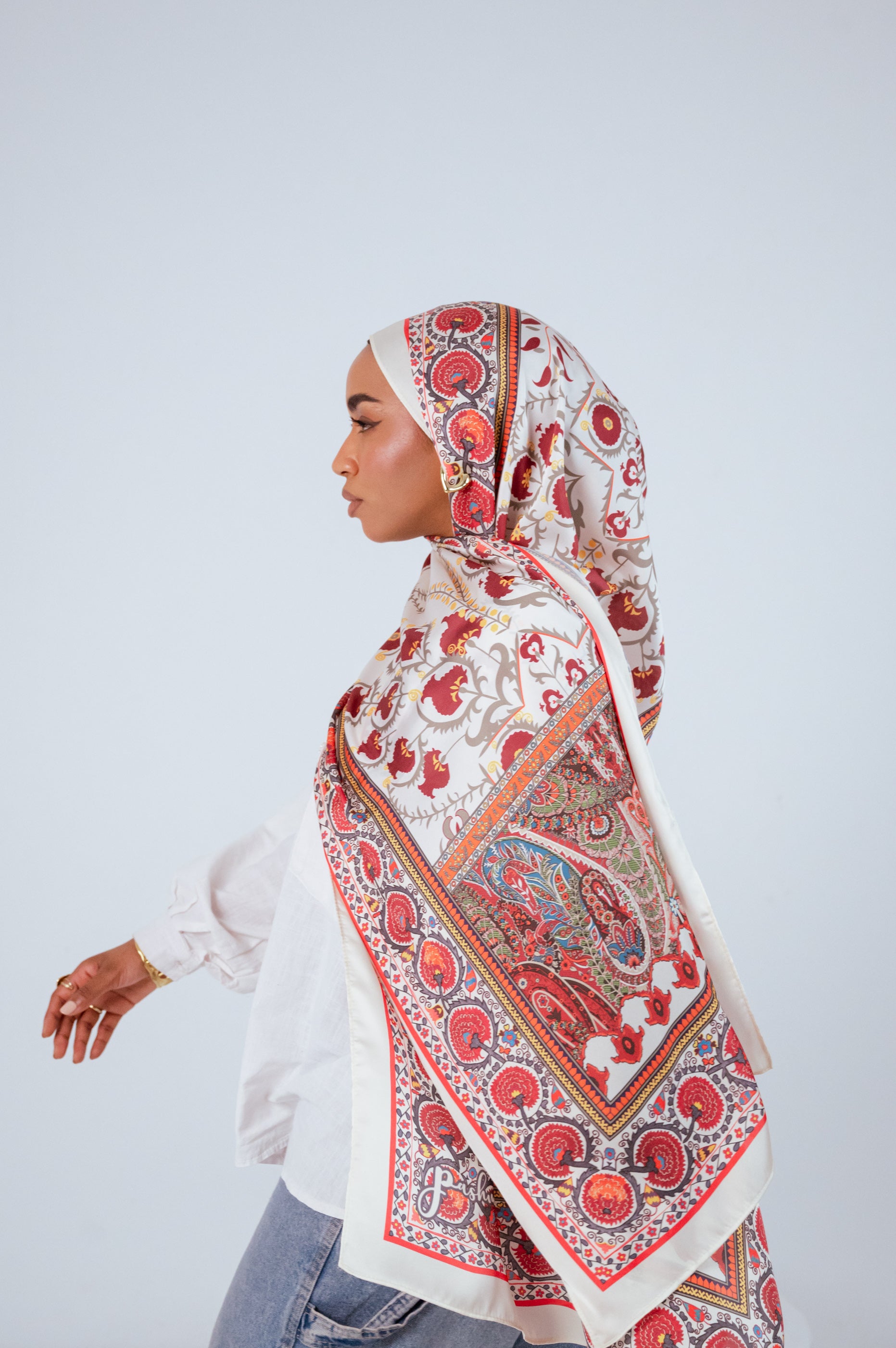 Model walking profile wearing Cairo Nights Satin Hijab with flowing drape