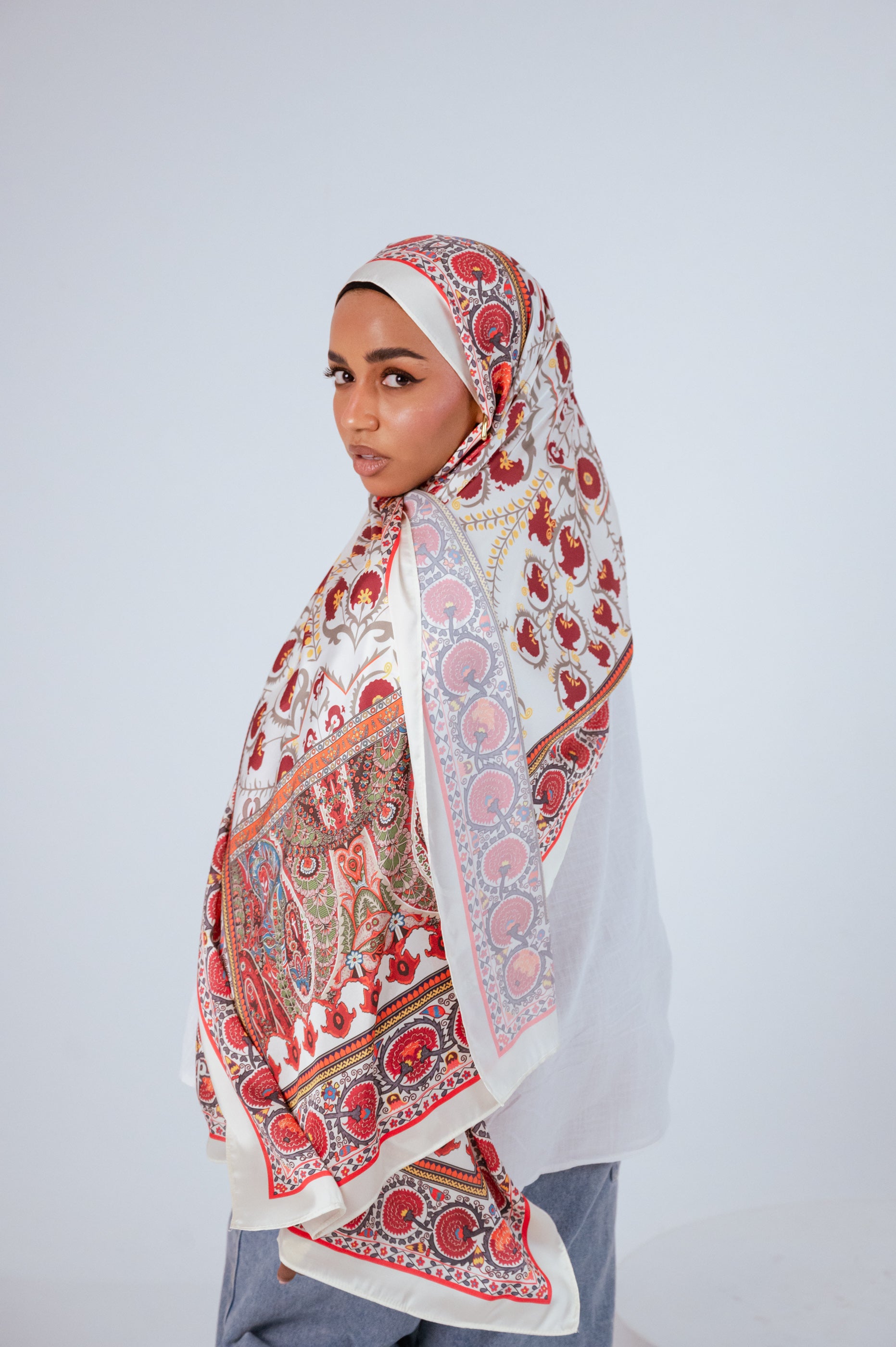 Model facing camera wearing Cairo Nights Satin Hijab with full print visible