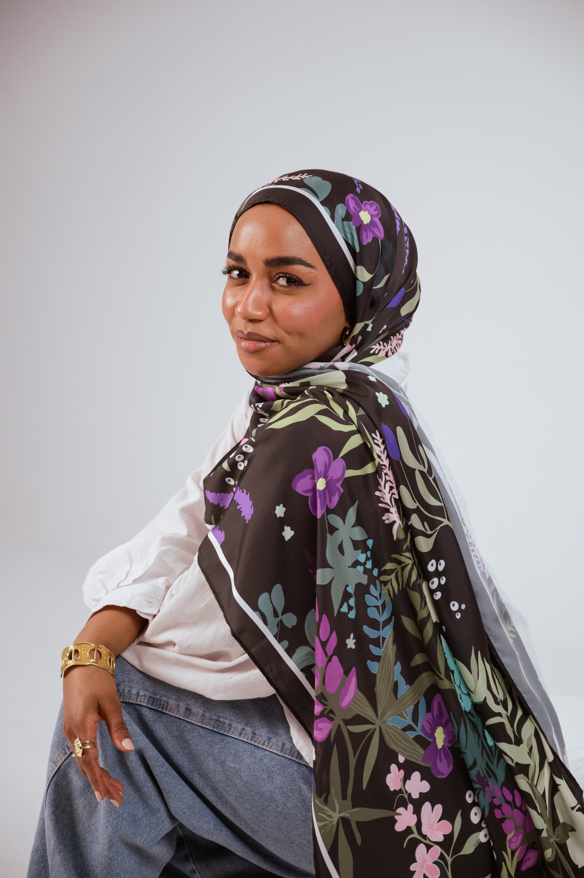 Side angle portrait showing floral satin hijab drape