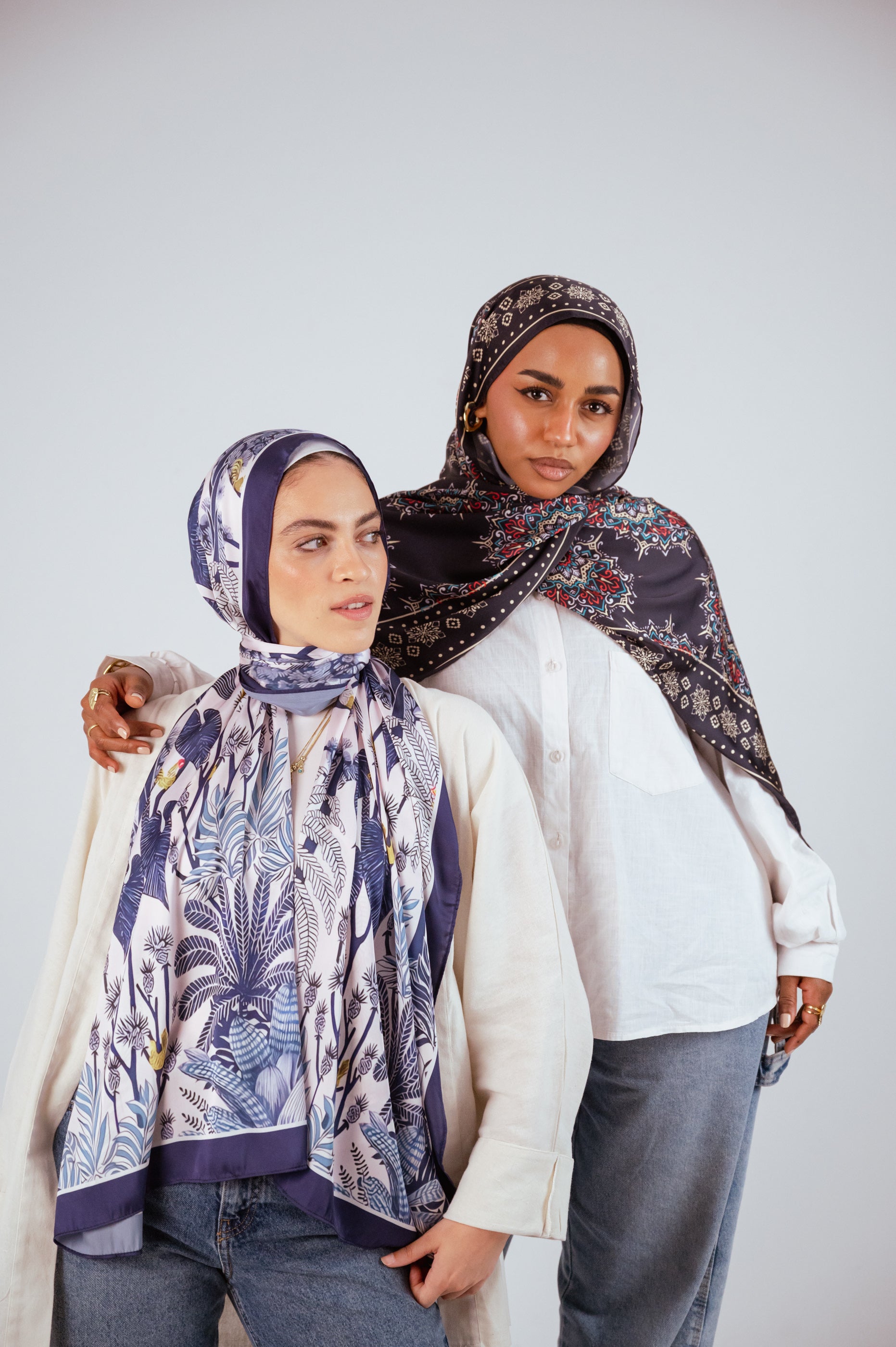 Models showcasing JAIDA’s Blooms of Hope Satin Hijab and Andalusia Satin Hijab, styled with neutral outfits.