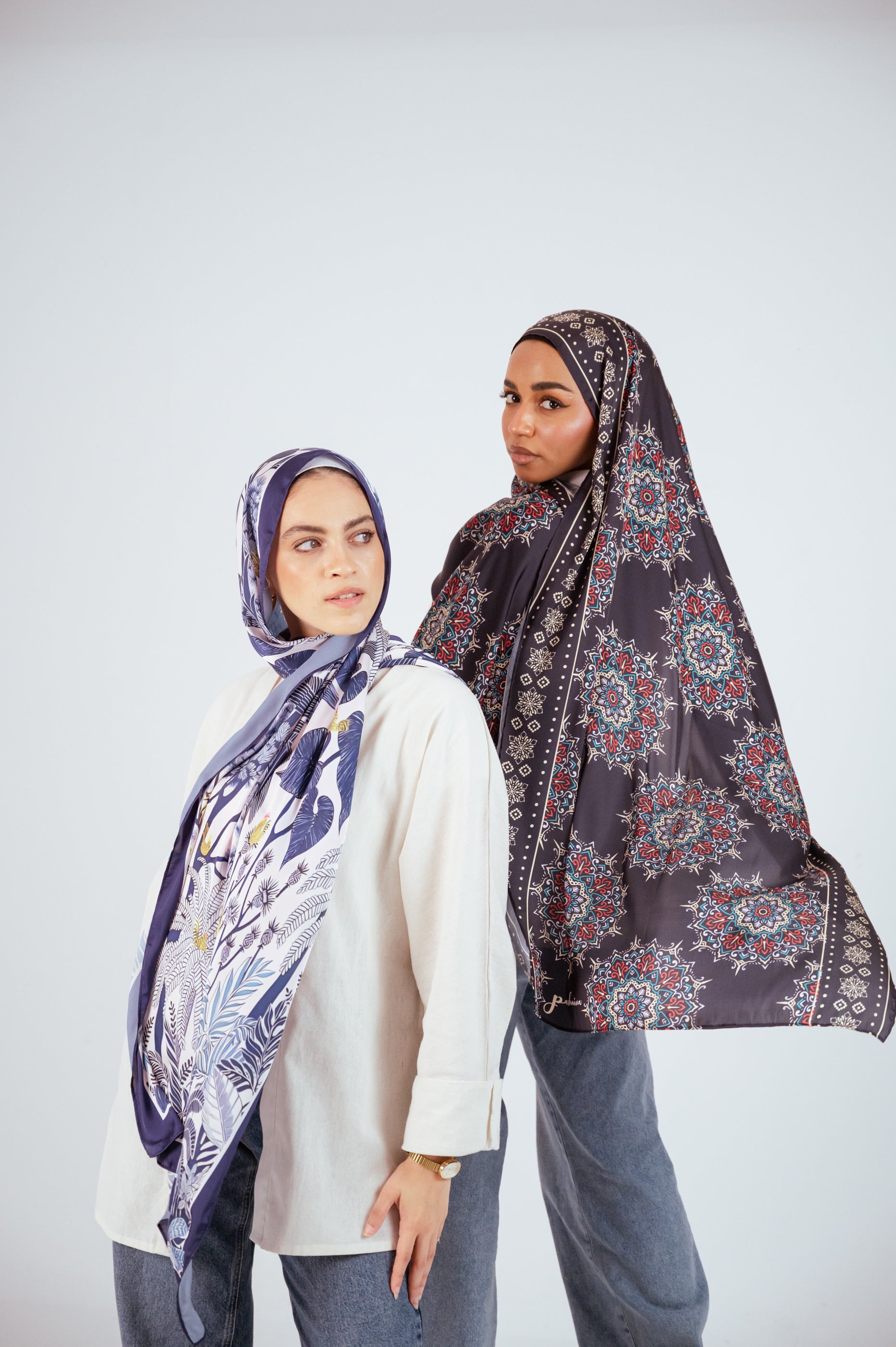 Stylish duo wearing JAIDA’s Blooms of Hope and Andalusia Satin Hijabs, showcasing print detail and drape.