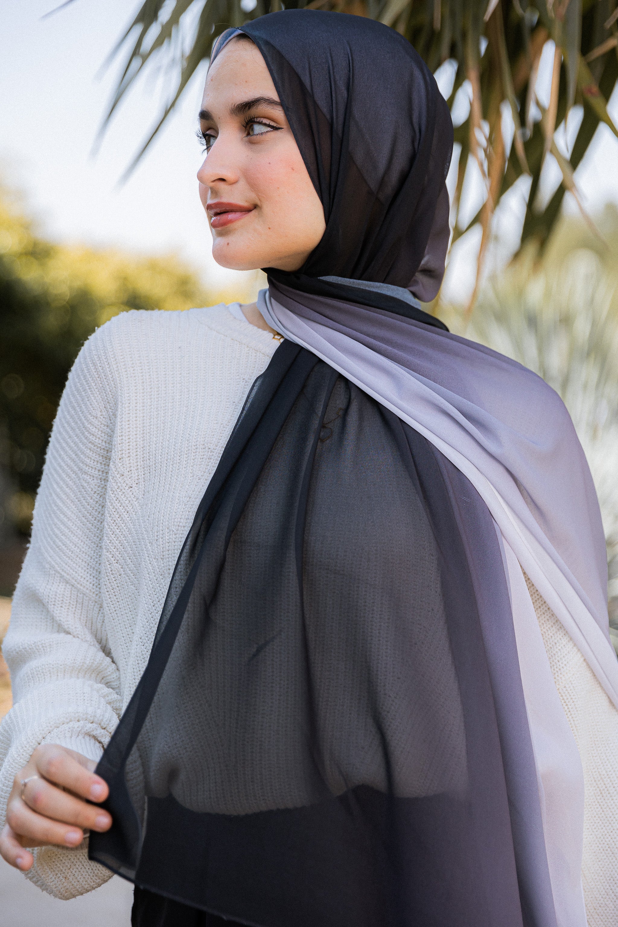 Close-up of Lunar Mist luxury chiffon showing the smooth transition from black through smoke to silver