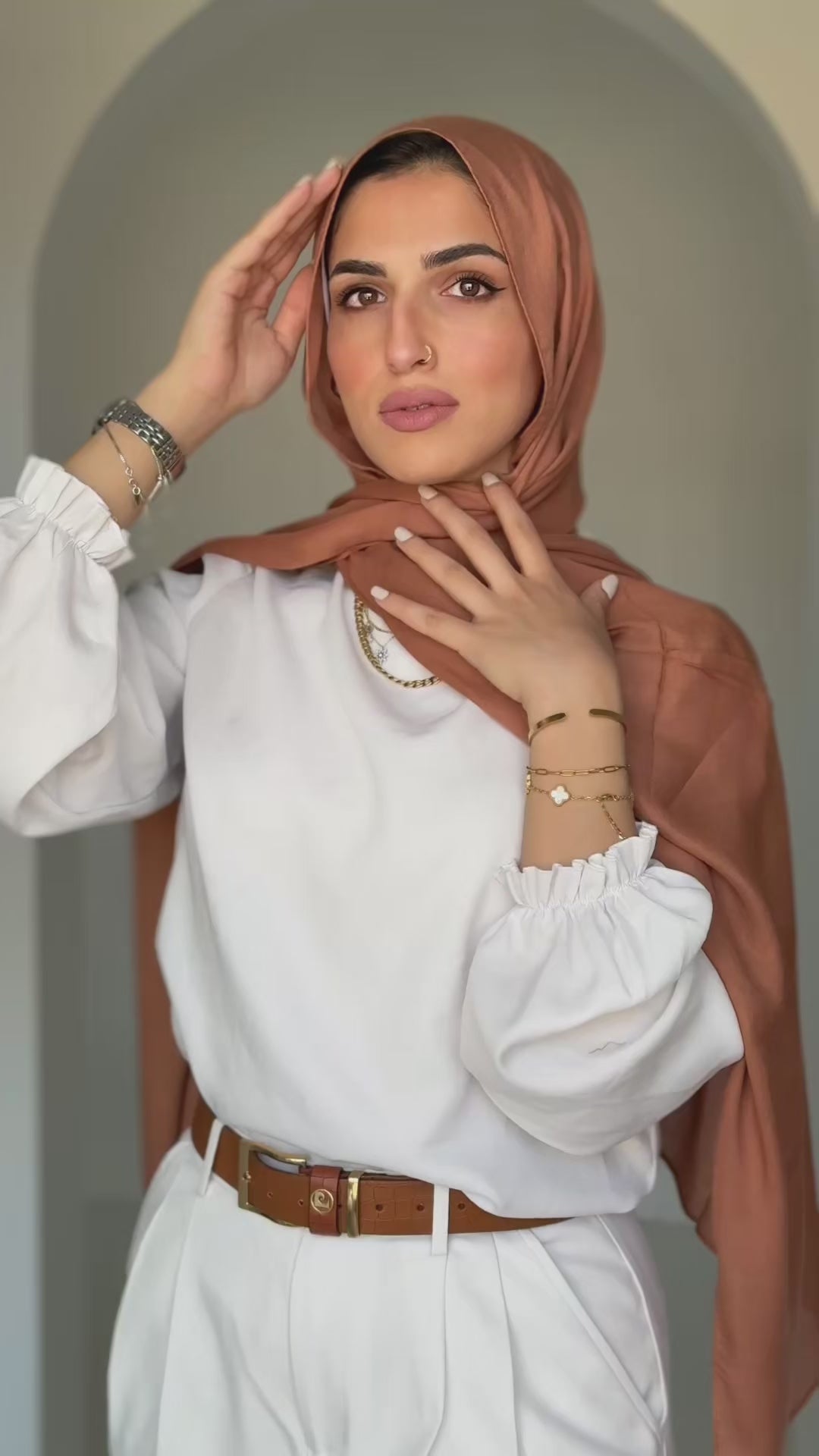 Sahara Dusk hijab moving gently in natural light, revealing golden tones and fluid drape.