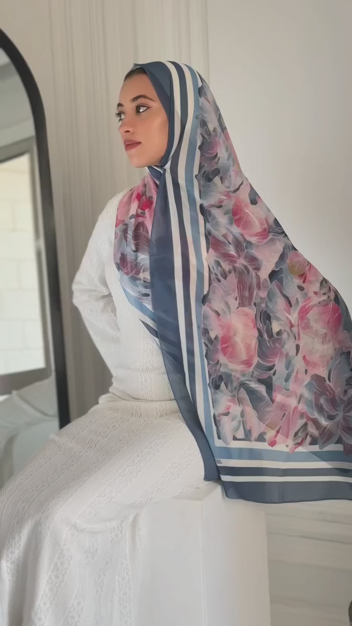 Model drapes the Rose Petal Gelato hijab in soft sunlight. The chiffon fabric flows gently as she turns, revealing the delicate blush-pink hue and airy texture. A close-up captures the hijab’s elegant sheen and lightweight drape in motion.