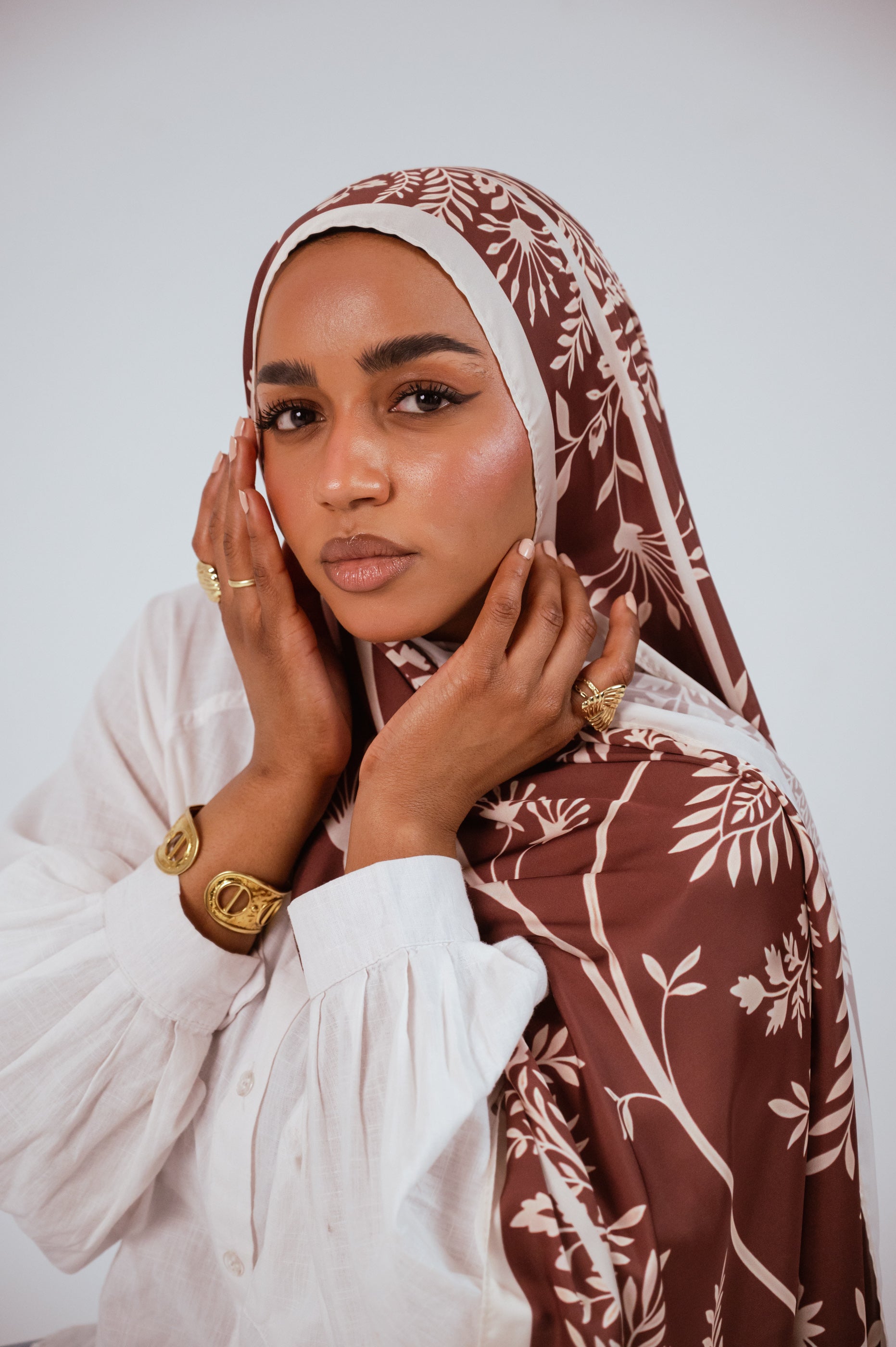 Elegant portrait of Rose of Petra satin hijab styled with gold jewelry.