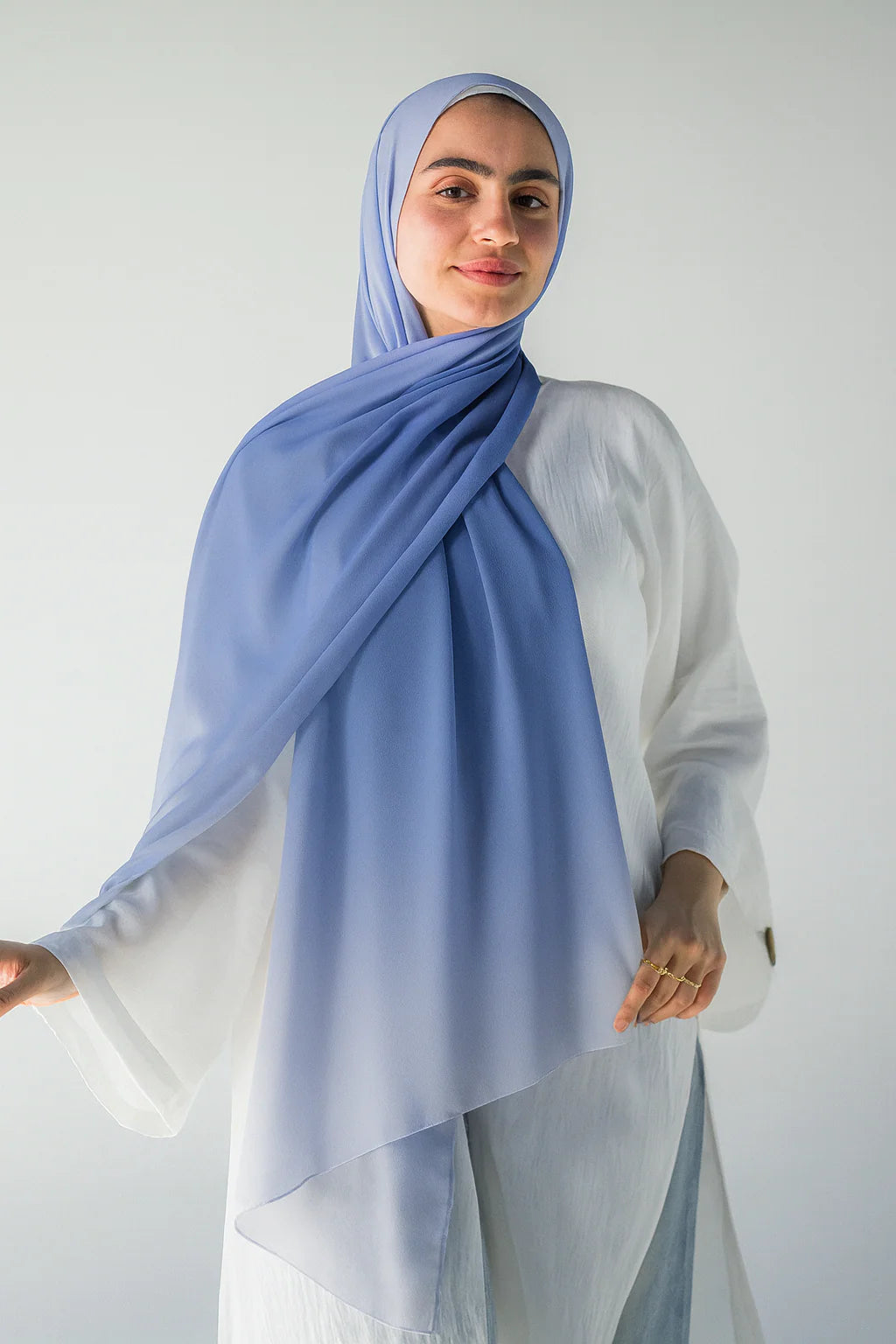 Sky Topaz chiffon hijab in motion, revealing the full cornflower blue to pale sky mist ombré gradient